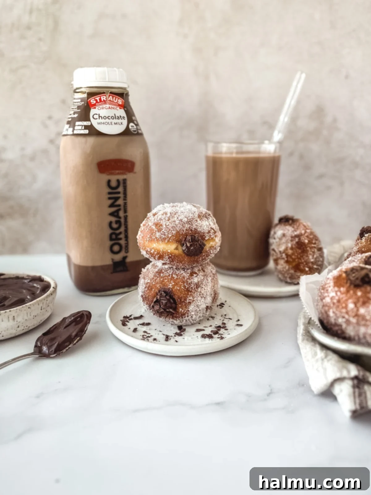 Decadent Chocolate Custard Brioche Donuts 8 A close-up shot of a single, perfectly golden and sugared brioche donut on a white background.
