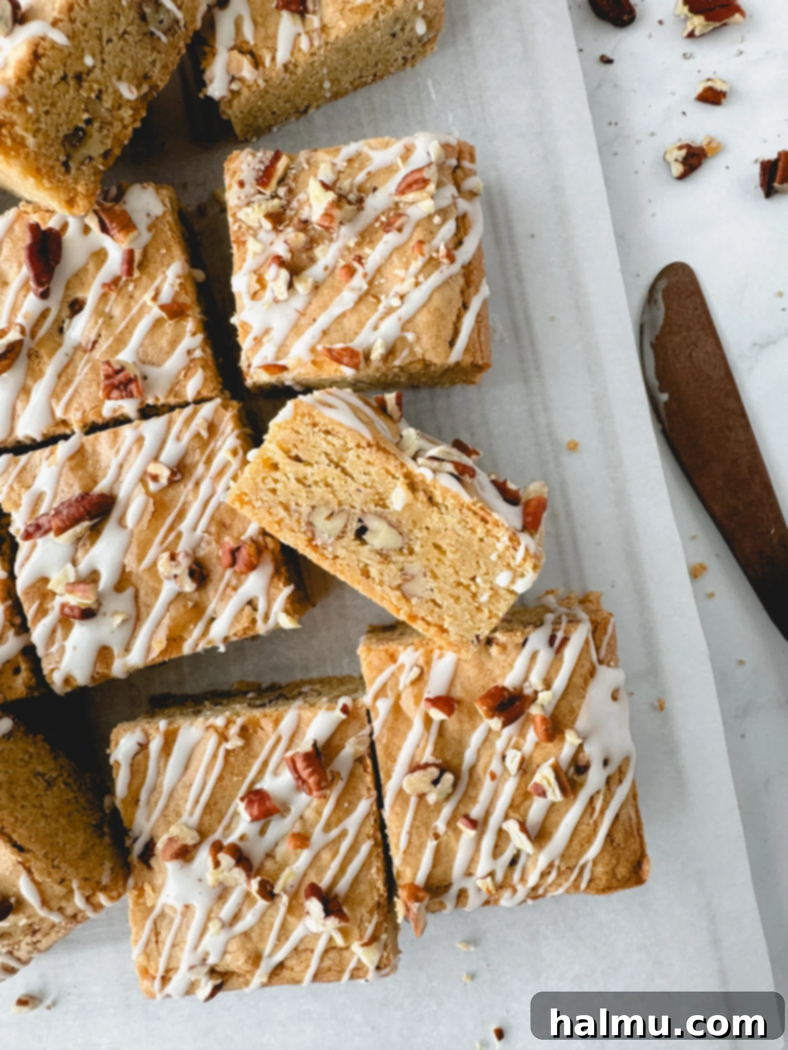 A close-up of a saucepan containing perfectly browned butter, with golden liquid and dark brown milk solids at the bottom, ready for making blondies.