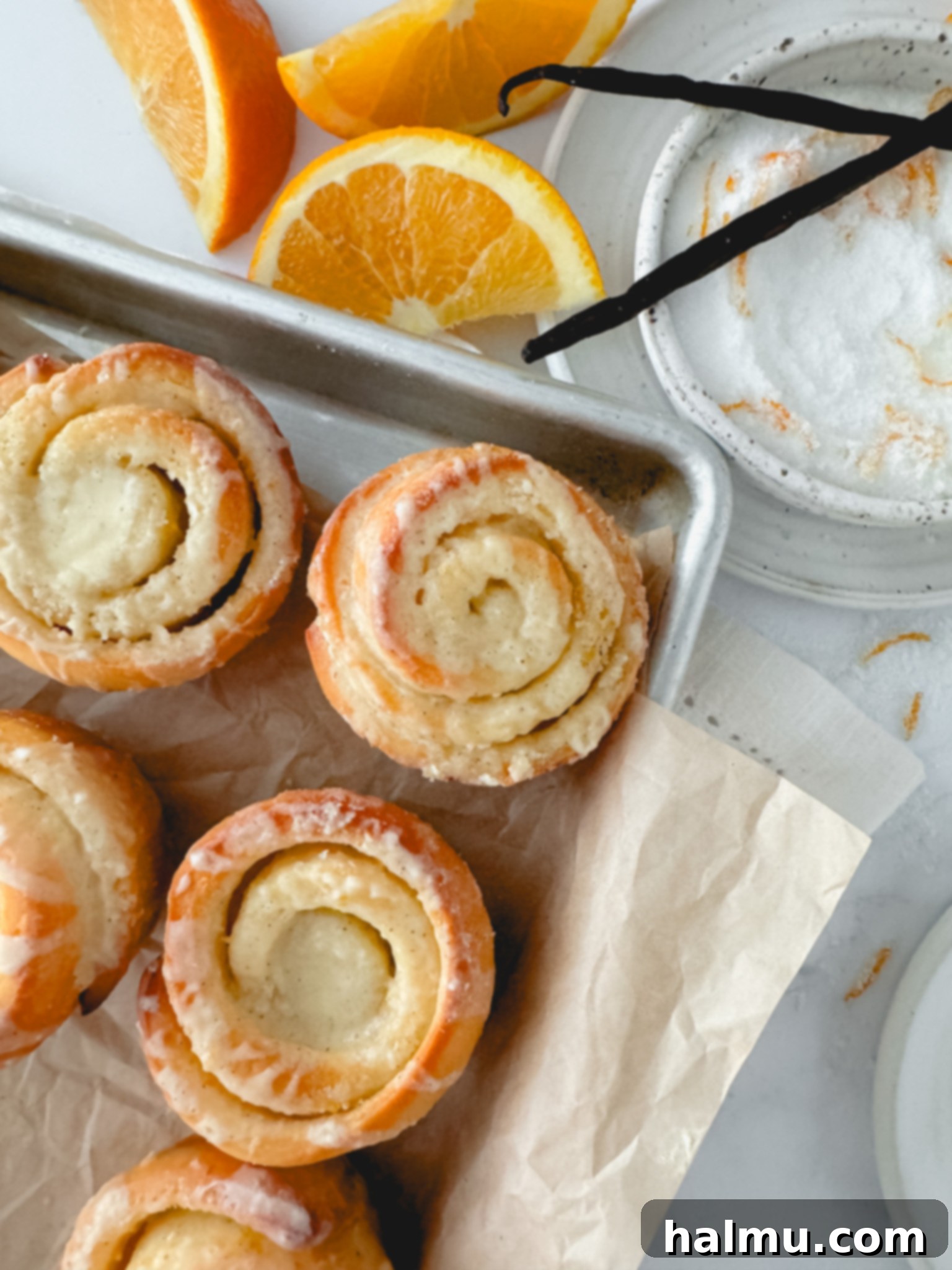 Plate of glazed Vanilla Orange Brioche Rolls