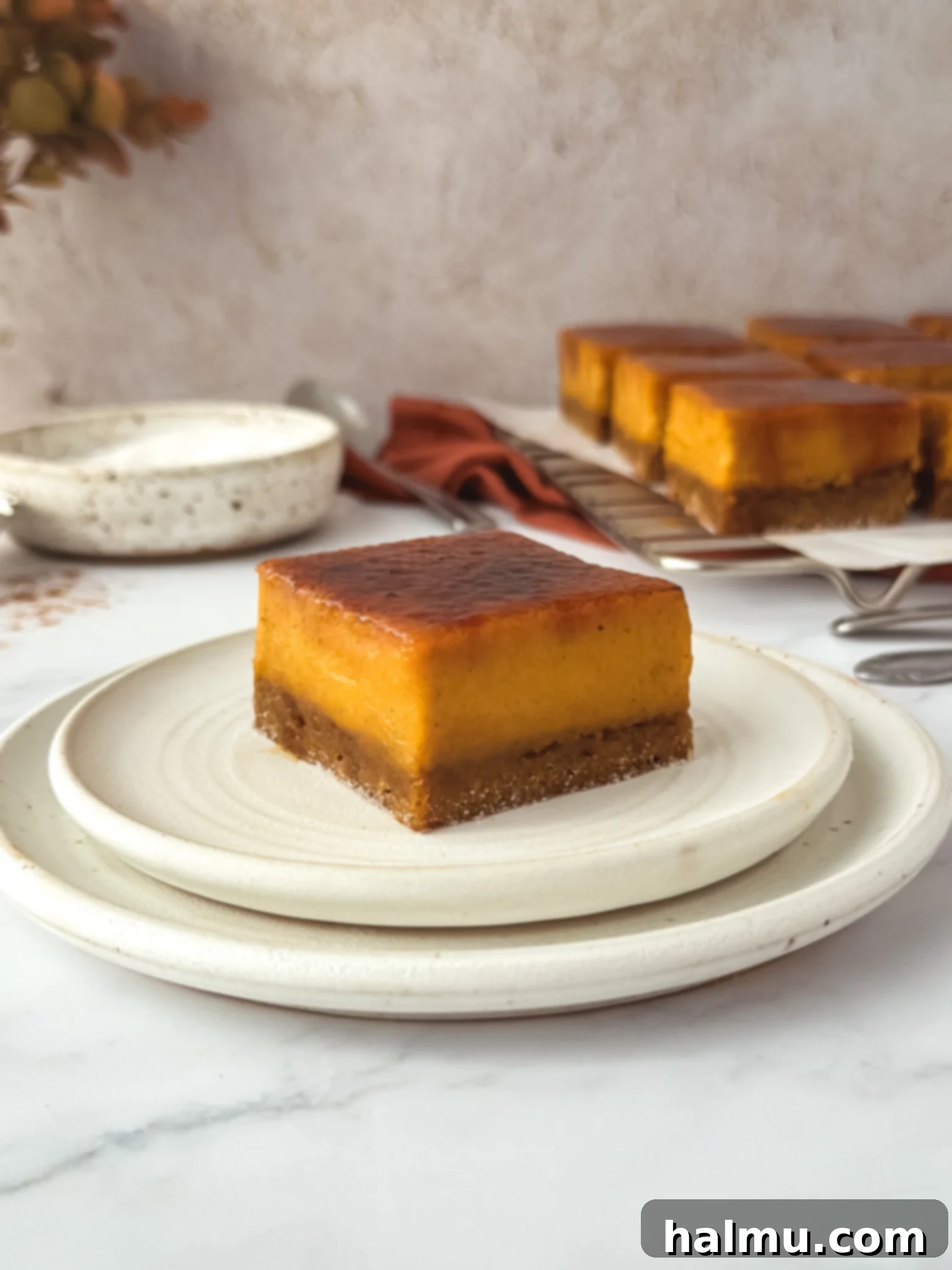 A close-up of a kitchen torch caramelizing the sugar topping on a Pumpkin Spice Crème Brûlée Bar.