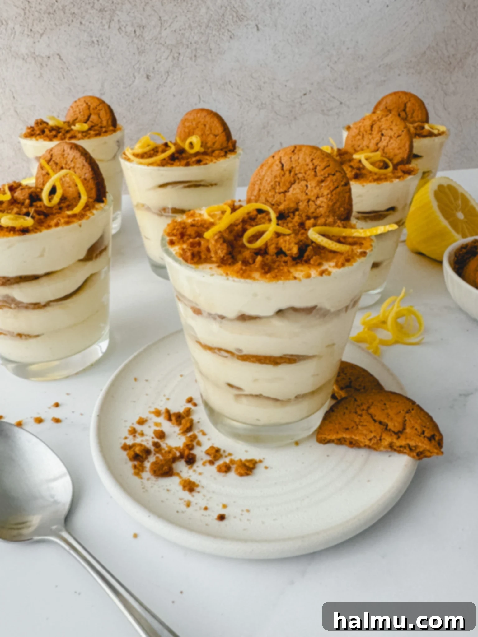 Zingy Gingersnap Tiramisu 6 An assortment of fresh lemons, half-cut lemons, and gingersnap cookies arranged for the tiramisu recipe.