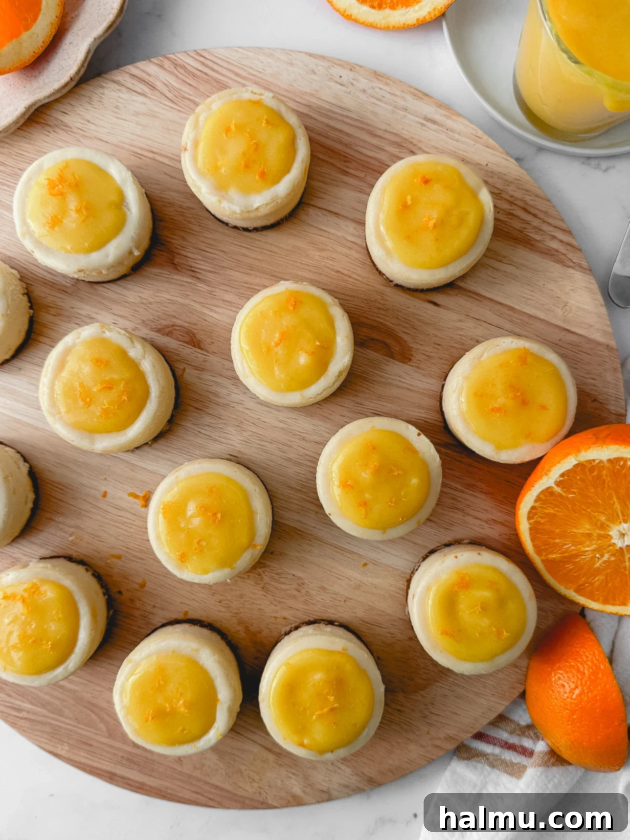 Close-up shot of the crumbly gingersnap cookie crust in a mini cheesecake pan, ready for baking.
