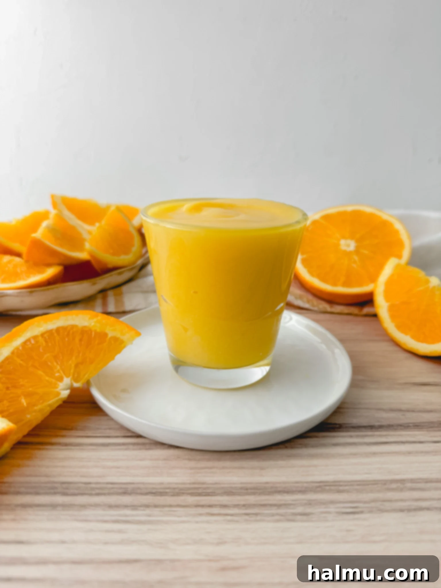 A jar of finished, chilled orange curd, ready to be used.
