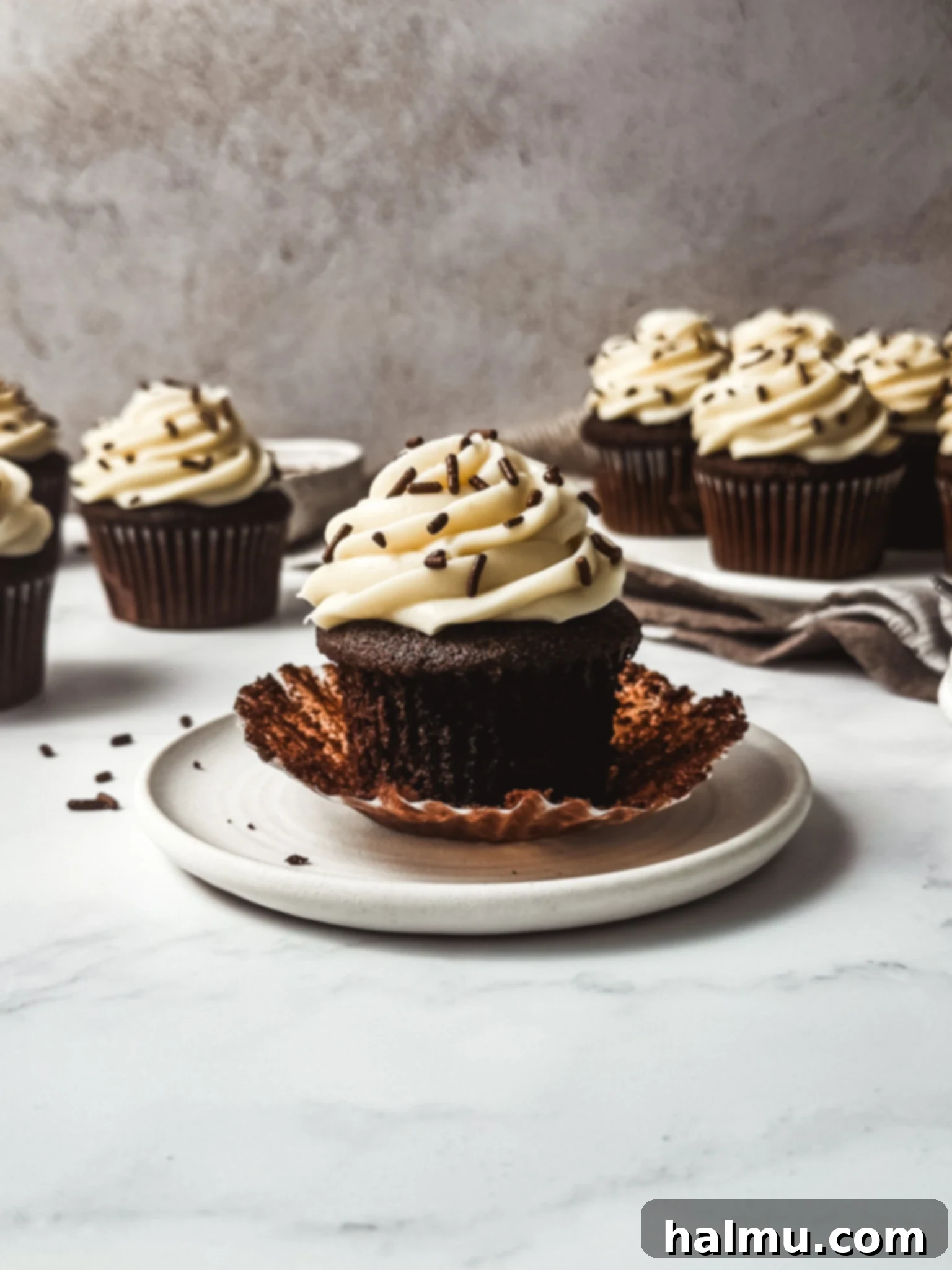 Rich Chocolate Cupcakes with Tangy Cream Cheese Frosting 6 An overhead shot of a freshly baked chocolate cupcake with a generous swirl of cream cheese frosting