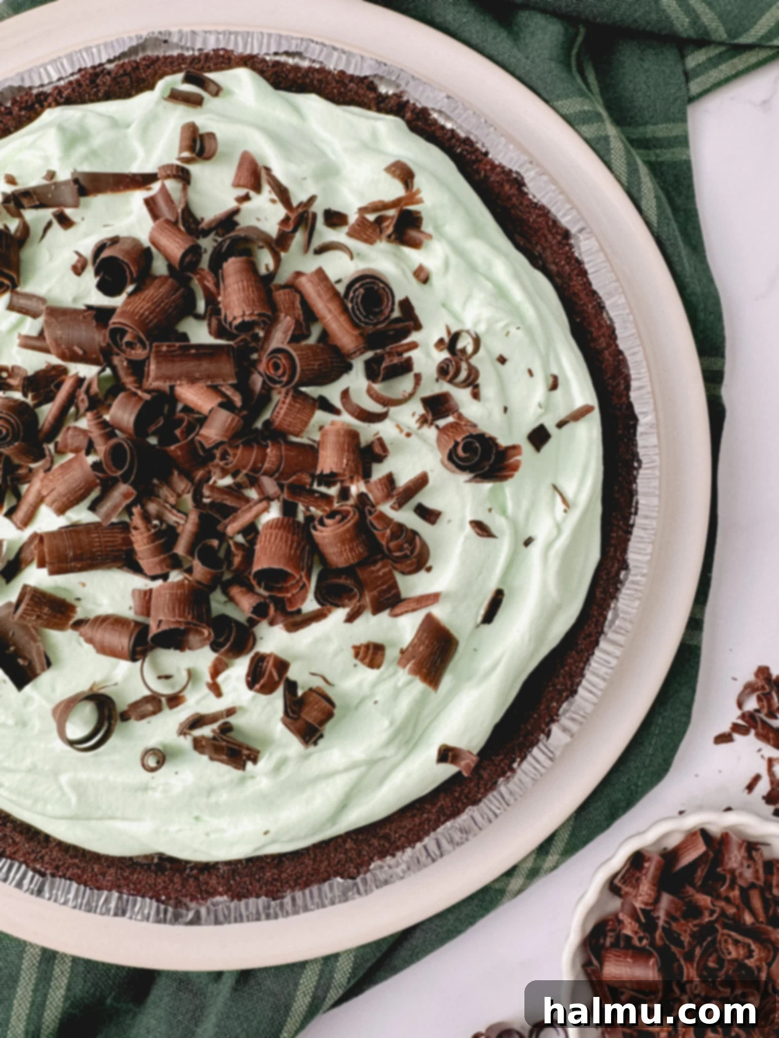 Close-up of the smooth, dark chocolate pastry cream filling a chocolate cookie crust, chilling in a pie dish.