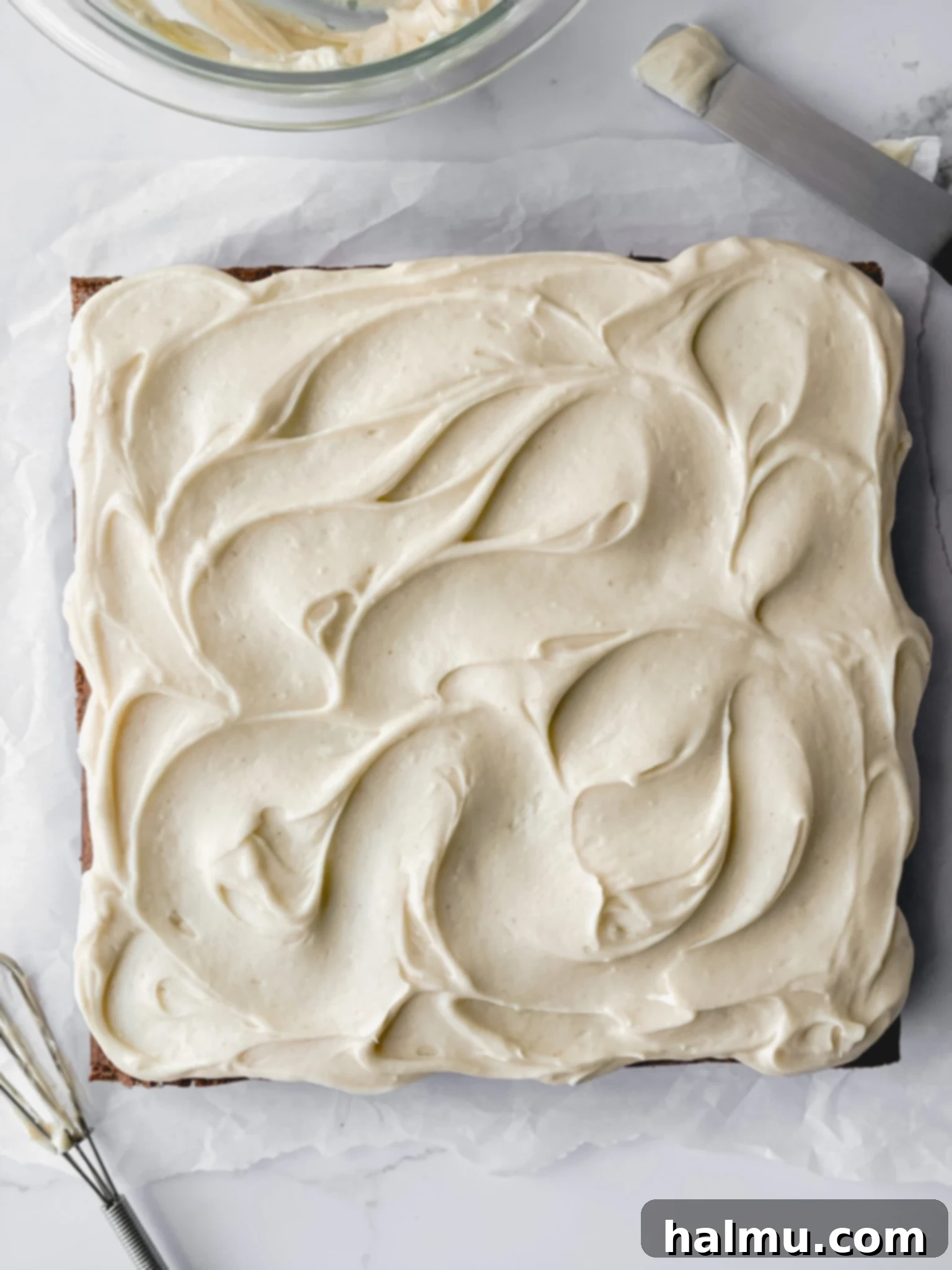 A slice of carrot cake with brown butter cream cheese frosting
