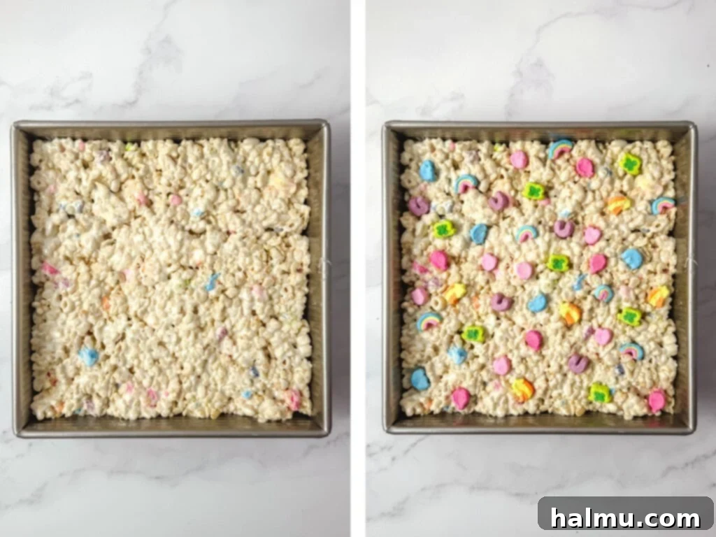 Lucky Charms Krispie Treats being pressed into a square pan