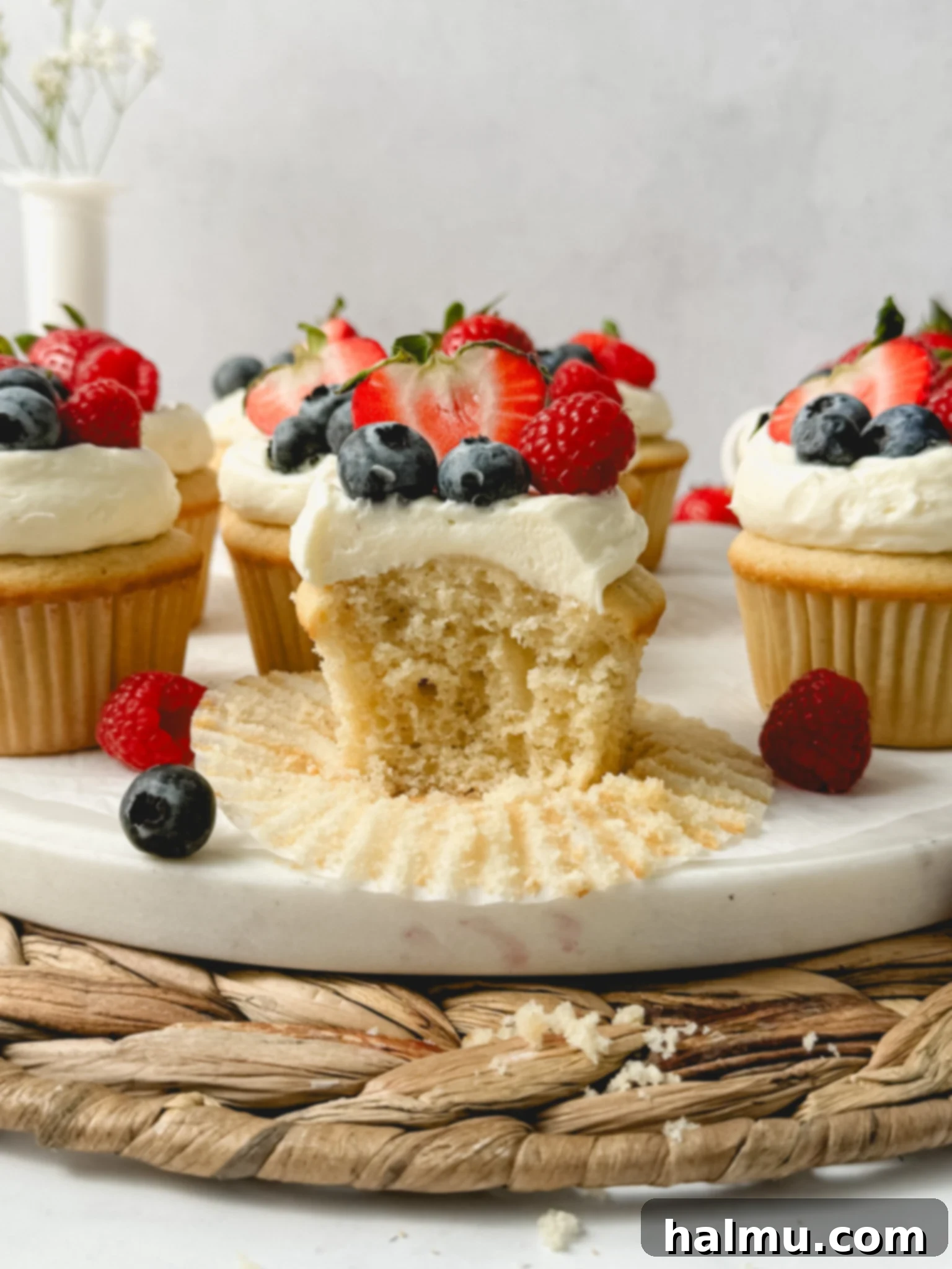 A close-up of a perfectly frosted Berry Chantilly Cupcake