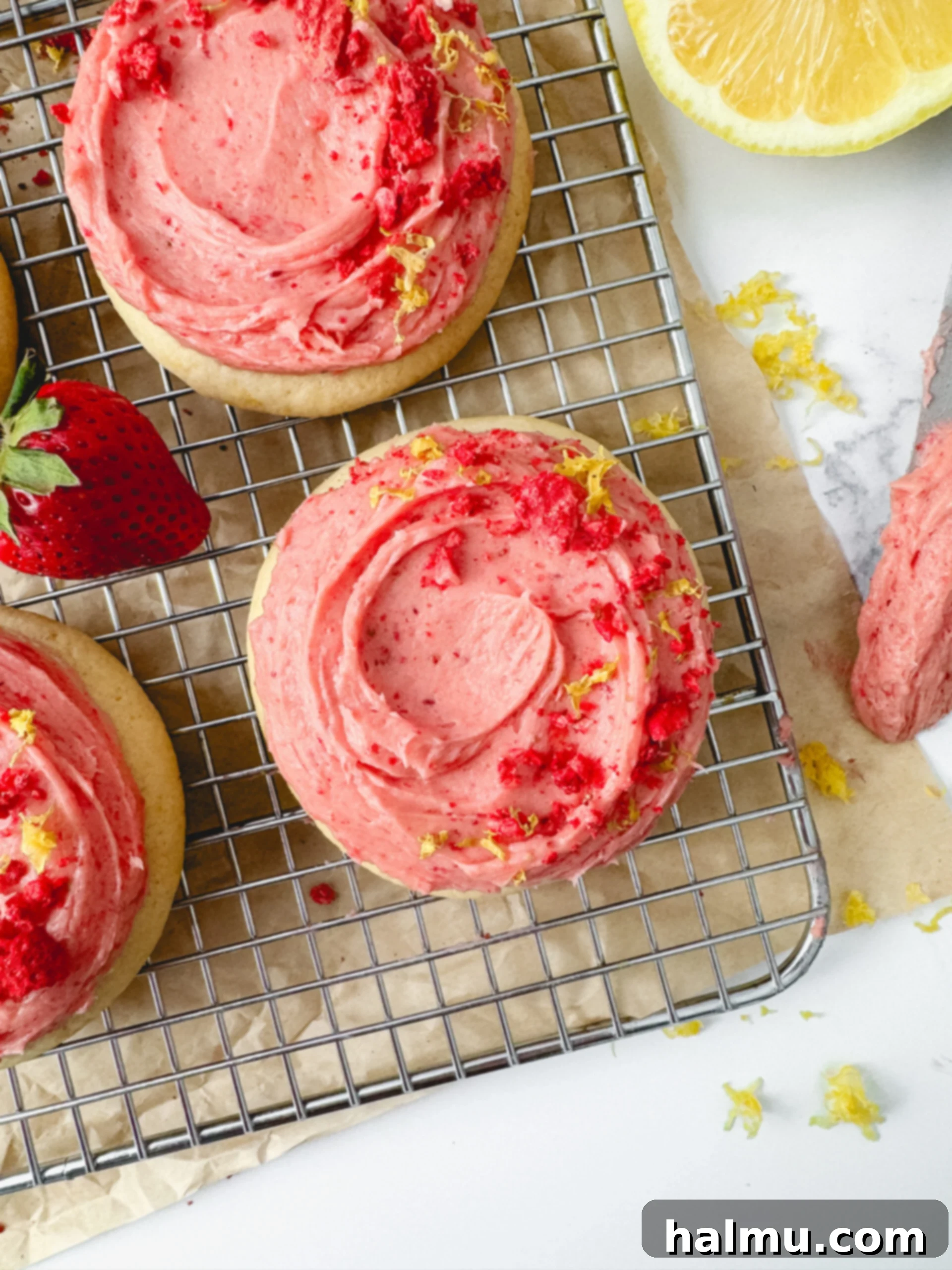 A stack of Strawberry Lemonade Cookies with pink frosting