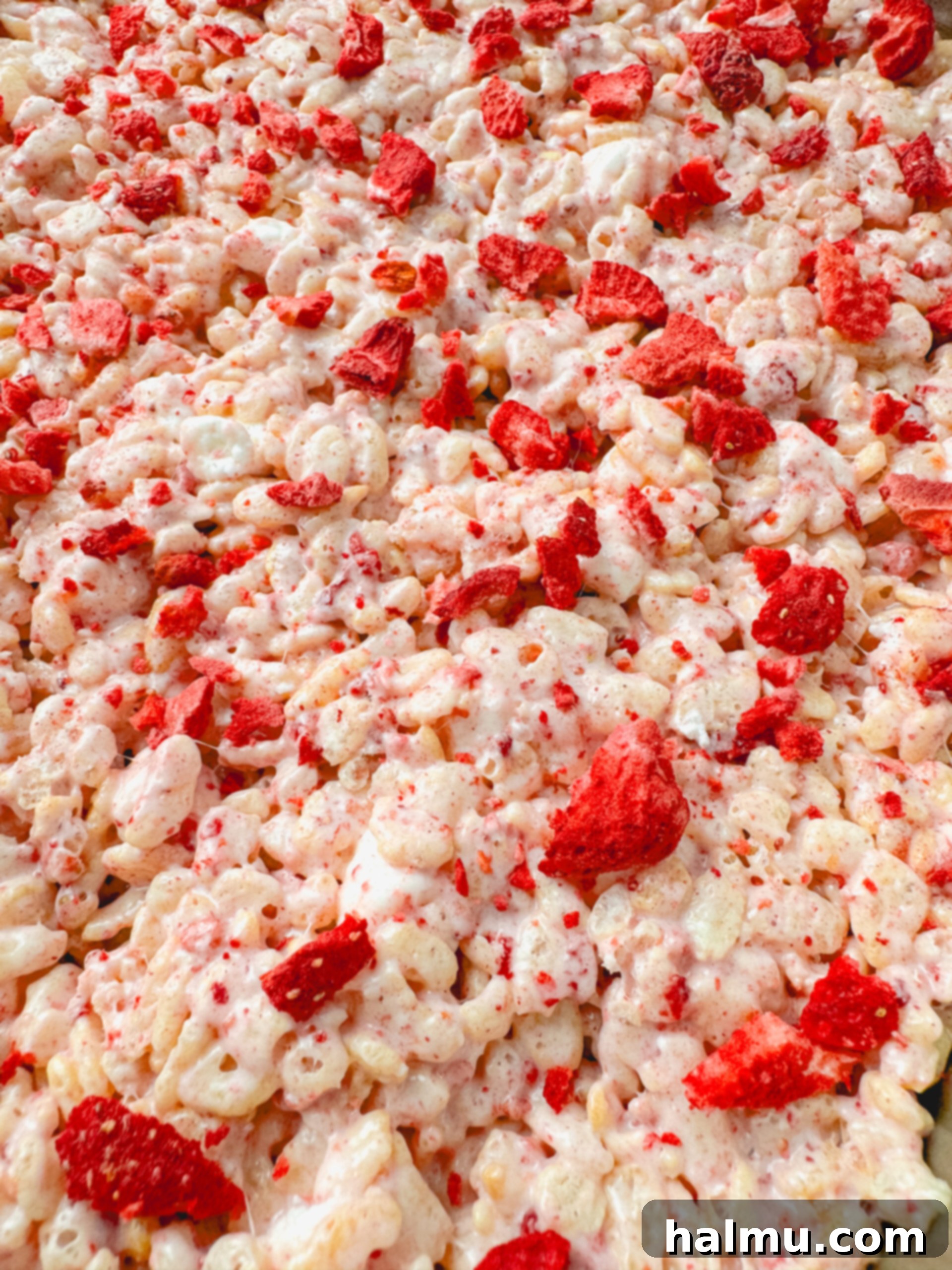 Ingredients laid out for Strawberry Rice Krispie Treats, including butter, marshmallows, freeze-dried strawberries, and rice cereal.