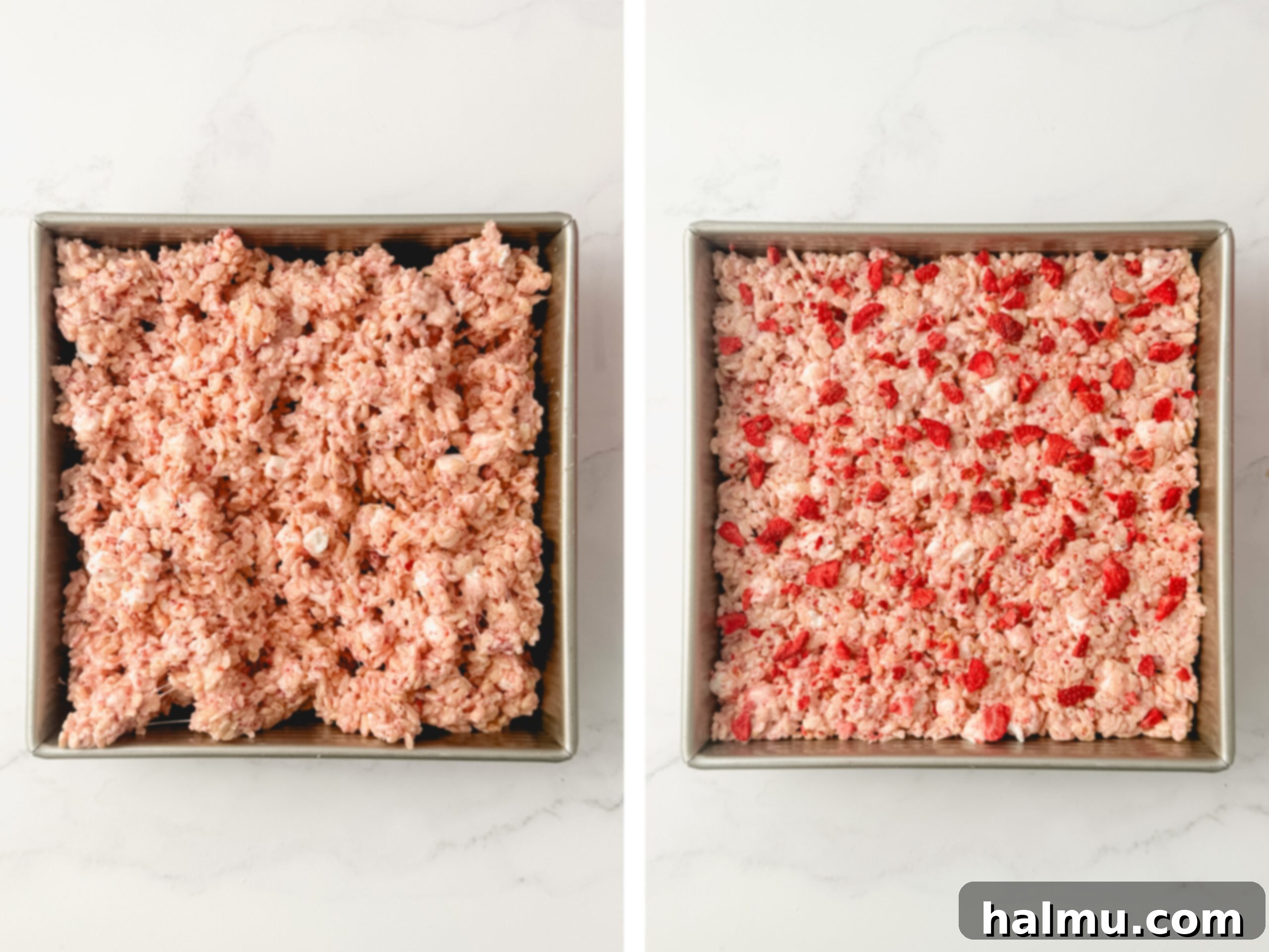 A pan filled with Strawberry Rice Krispie Treat mixture, topped with more crushed freeze-dried strawberries, ready to cool and set.