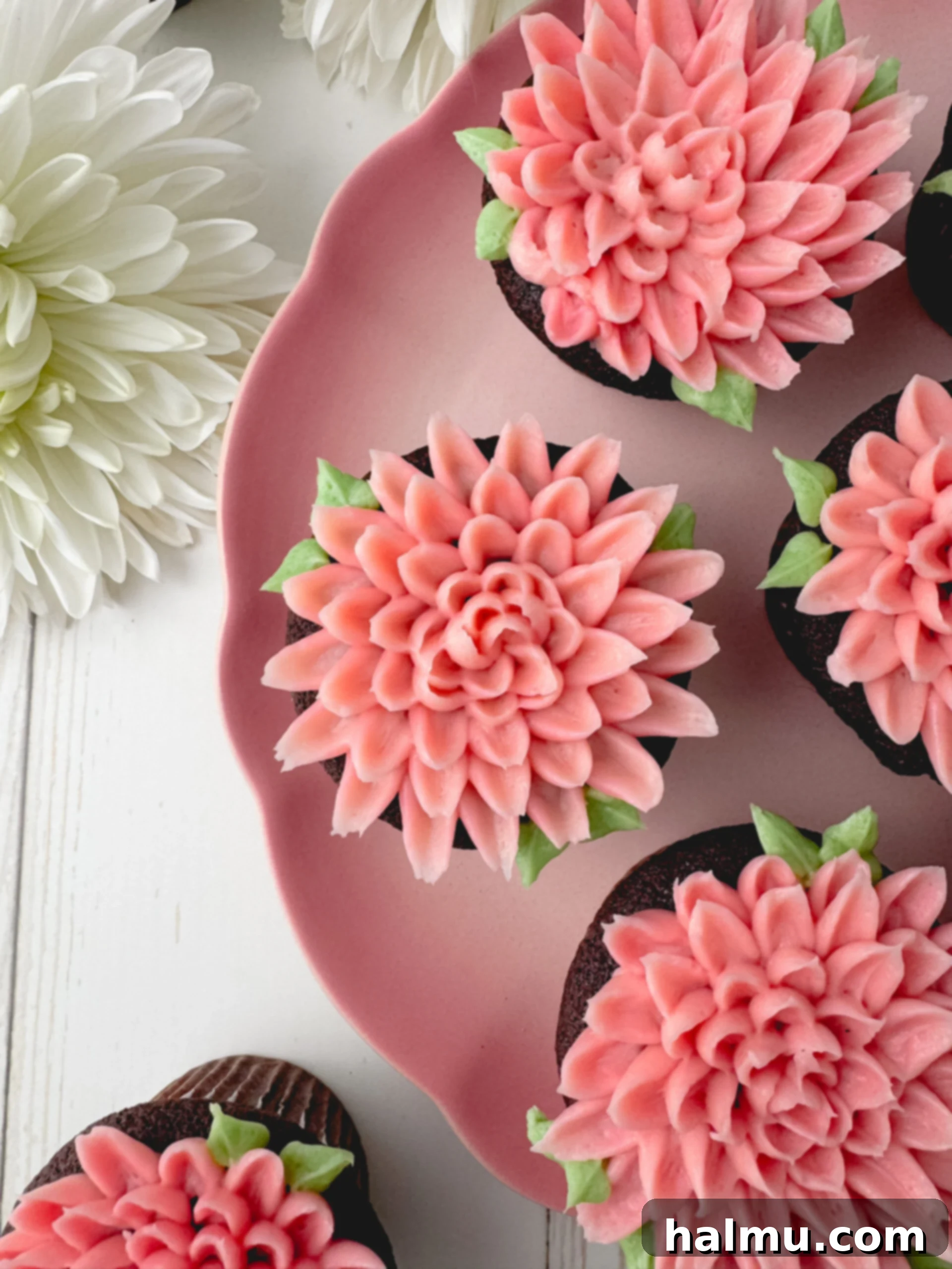 Cupcake Candles 2 Delightful chocolate cupcakes adorned with beautiful two-toned pink buttercream chrysanthemum flowers, perfect for Mother's Day.