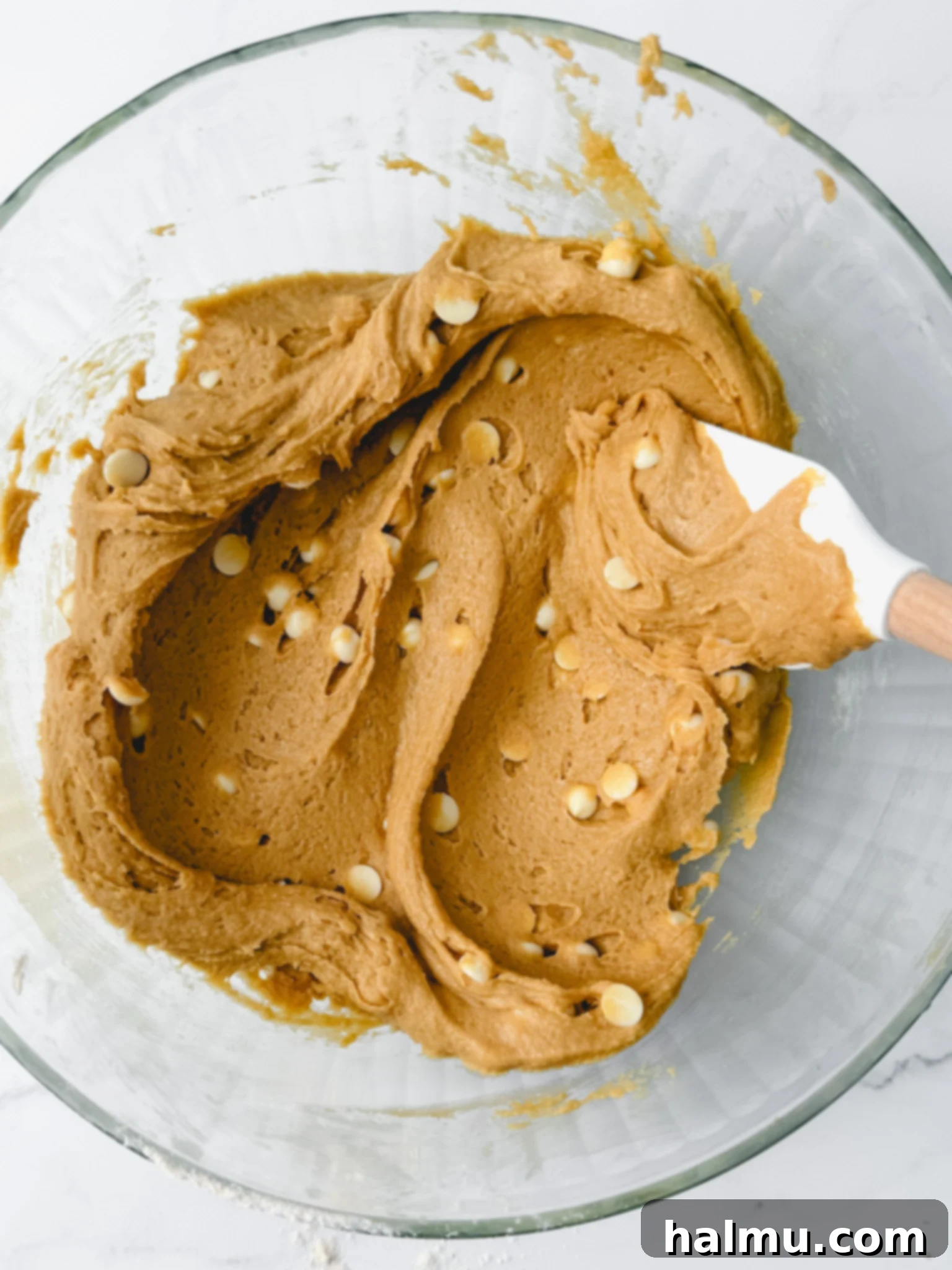 Speculoos Blondies 4 Biscoff Blondie batter being spread into a parchment-lined baking pan.