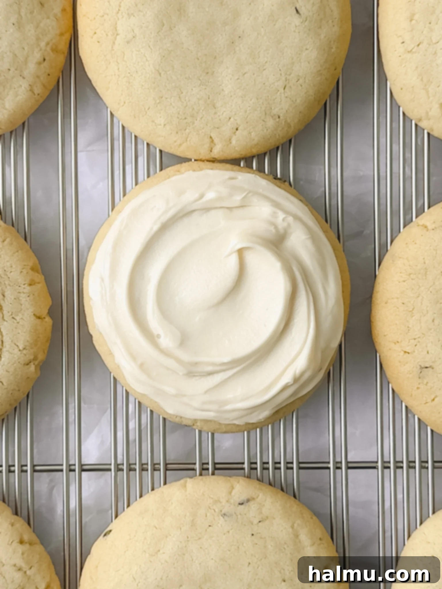 Lavender Kissed Honey Cookies 6 Honey Lavender Cookies being frosted on a wire rack.