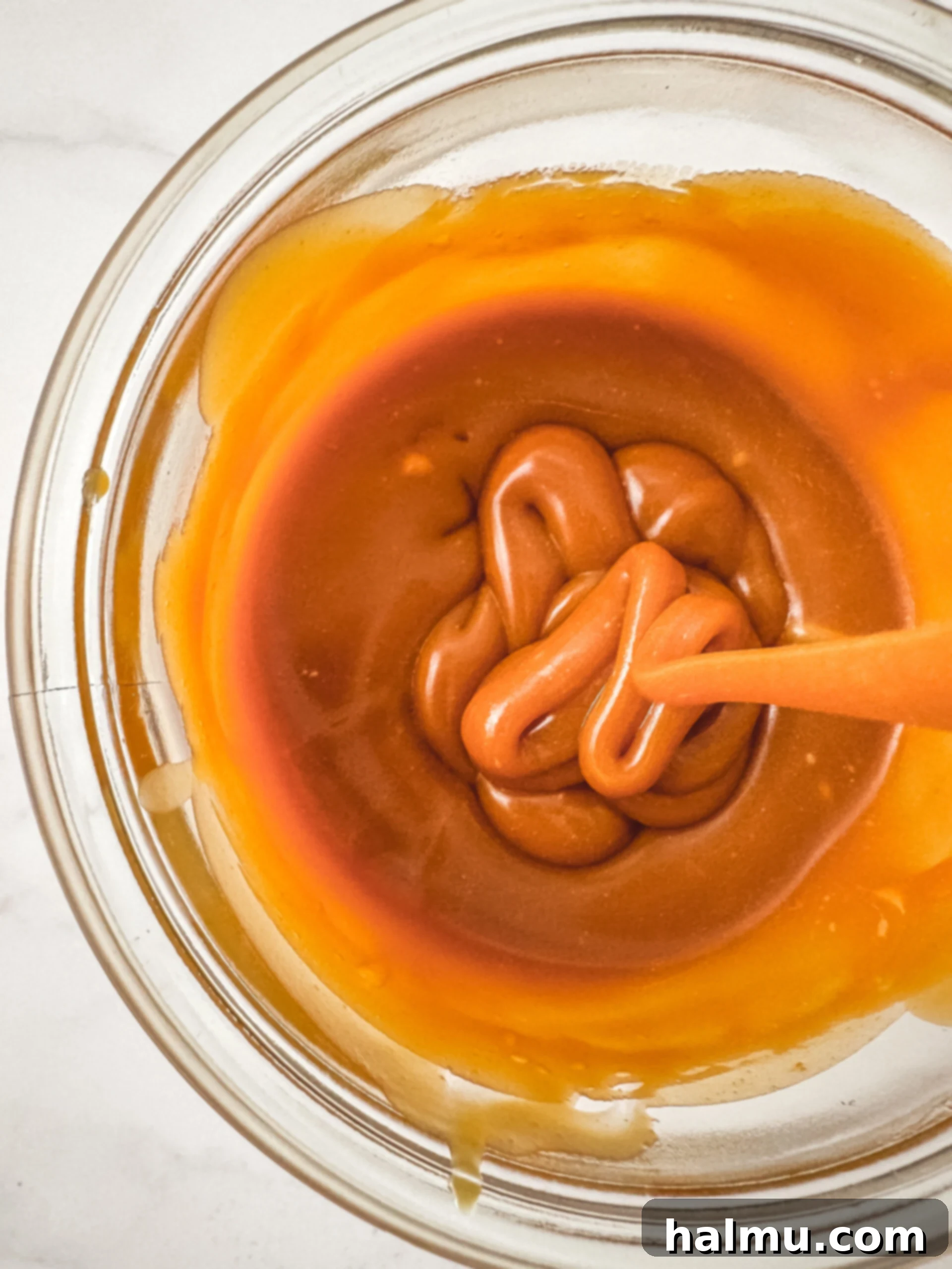 Rich, golden homemade caramel drizzled over a dessert