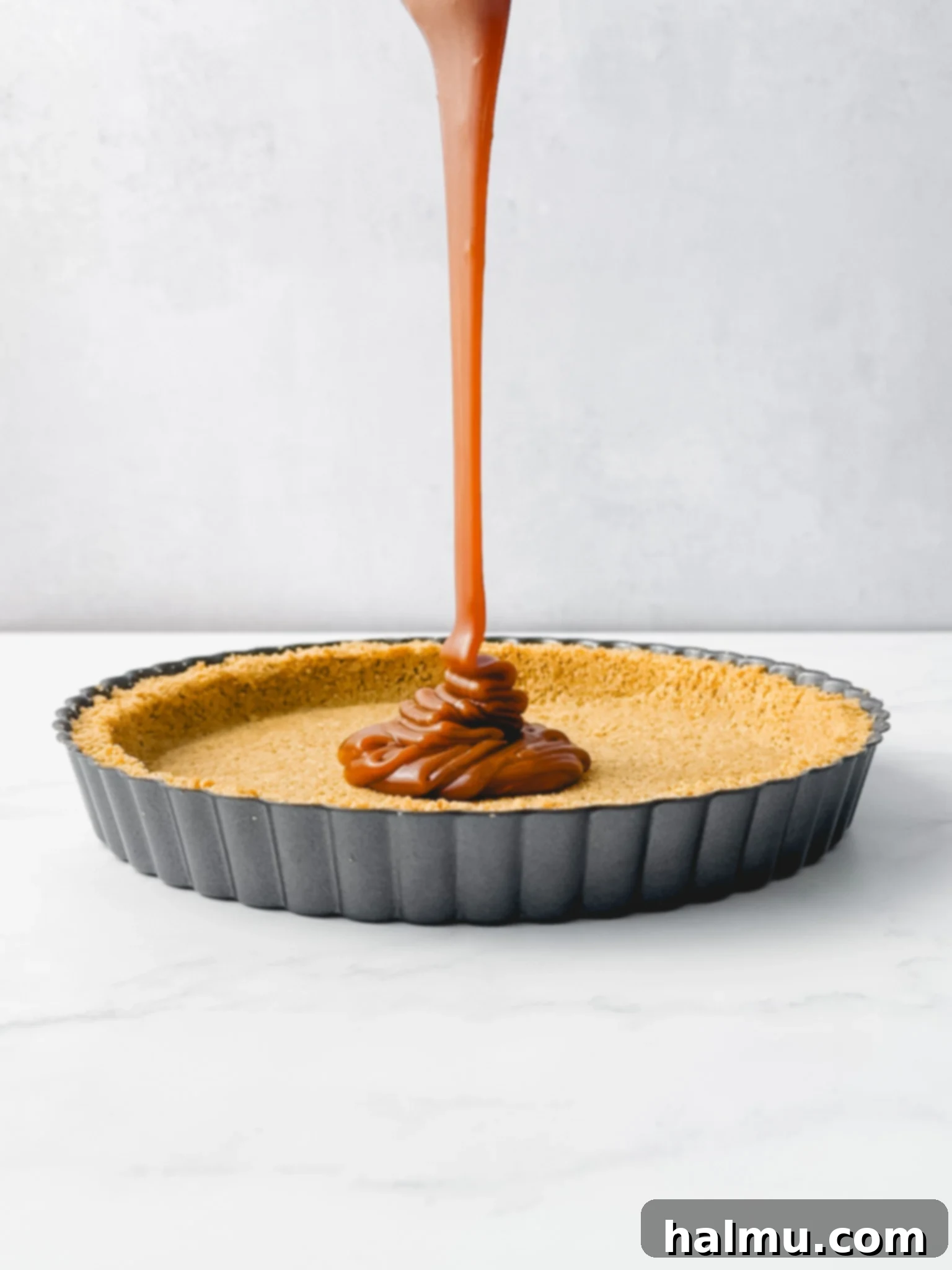 Close up of a spoon scooping homemade caramel