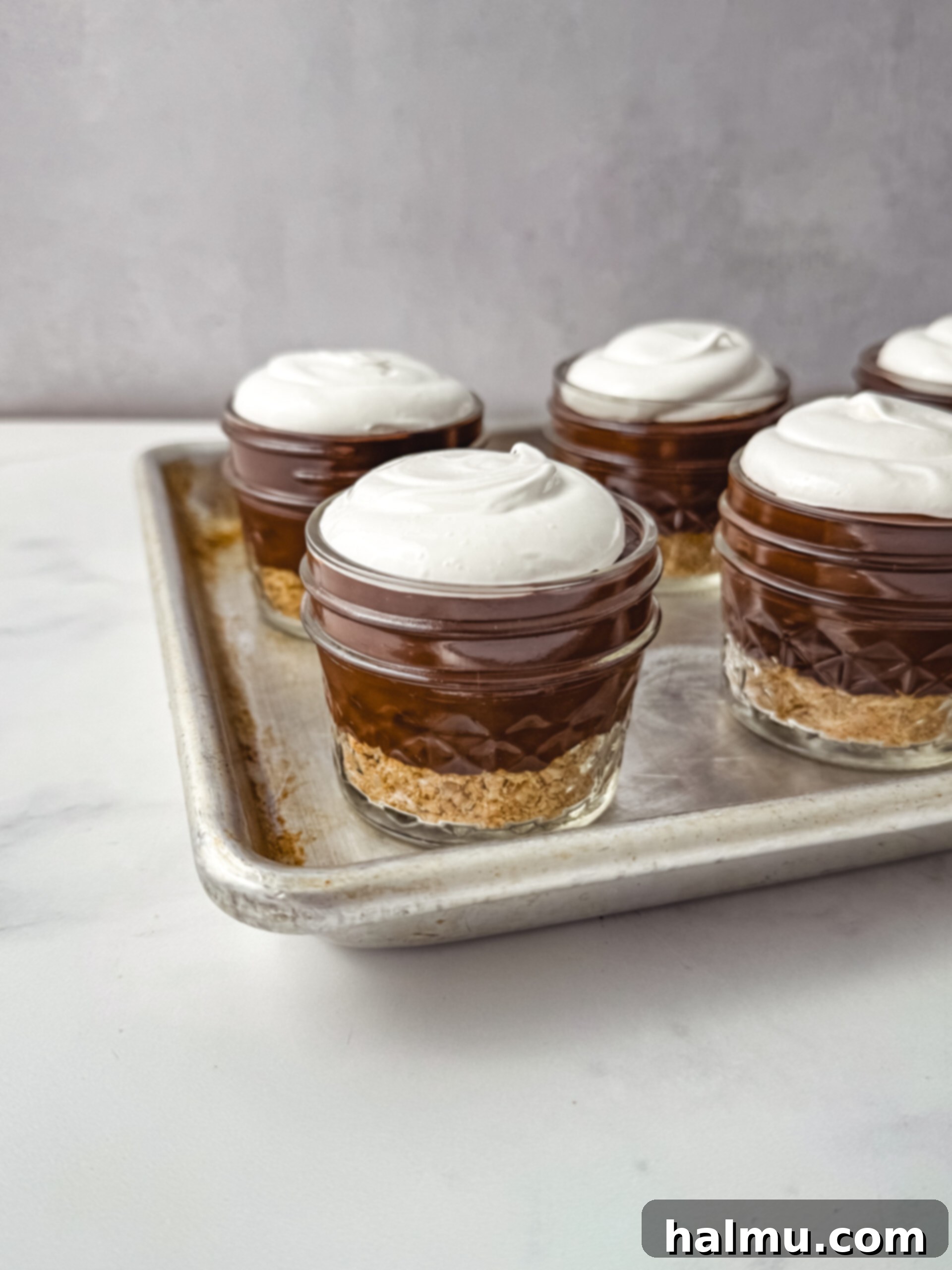 Pouring homemade chocolate pudding into a bowl, ready to be chilled.