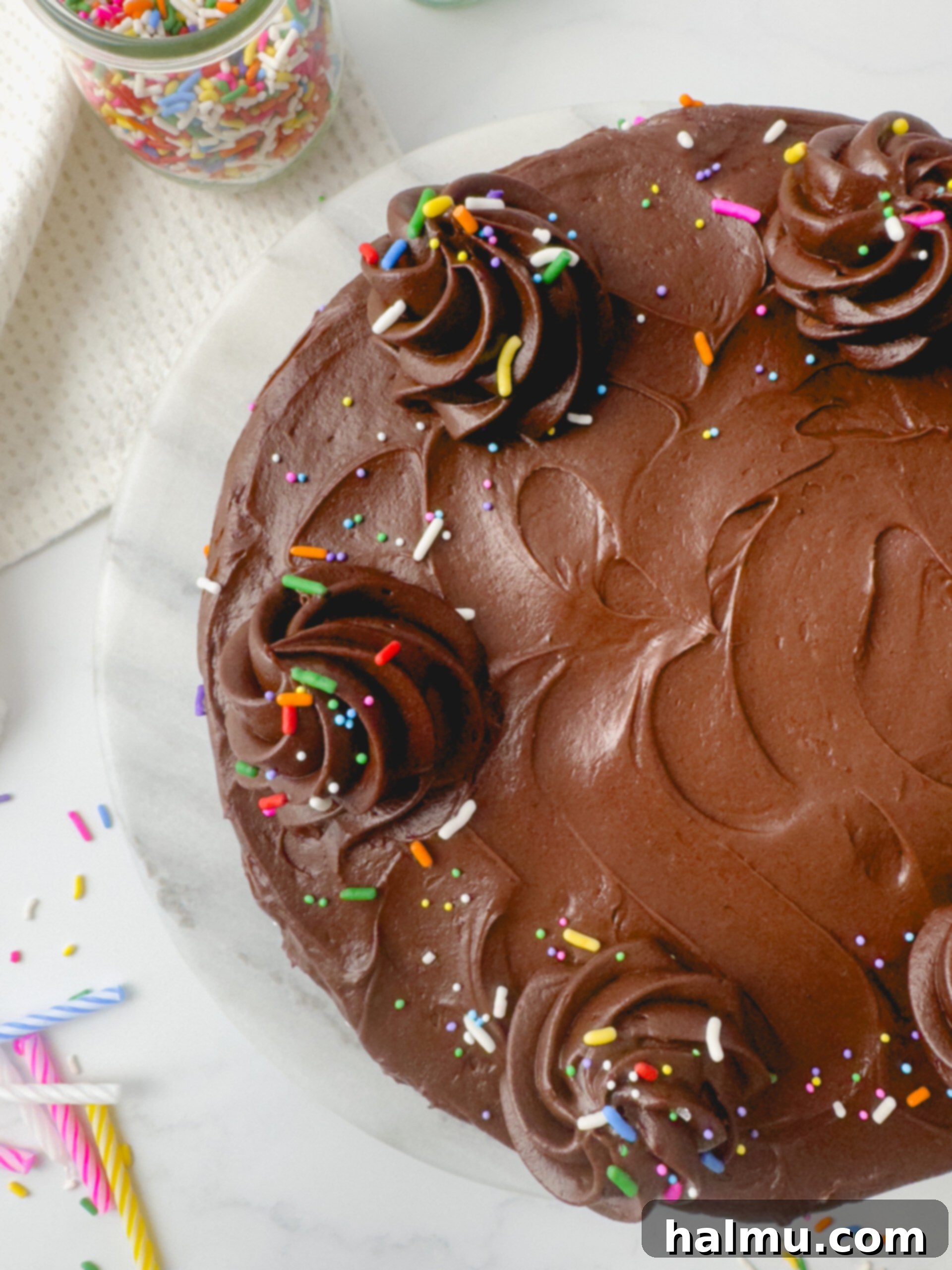 Confetti Birthday Cake with a slice removed, showing the three distinct layers of cake and frosting