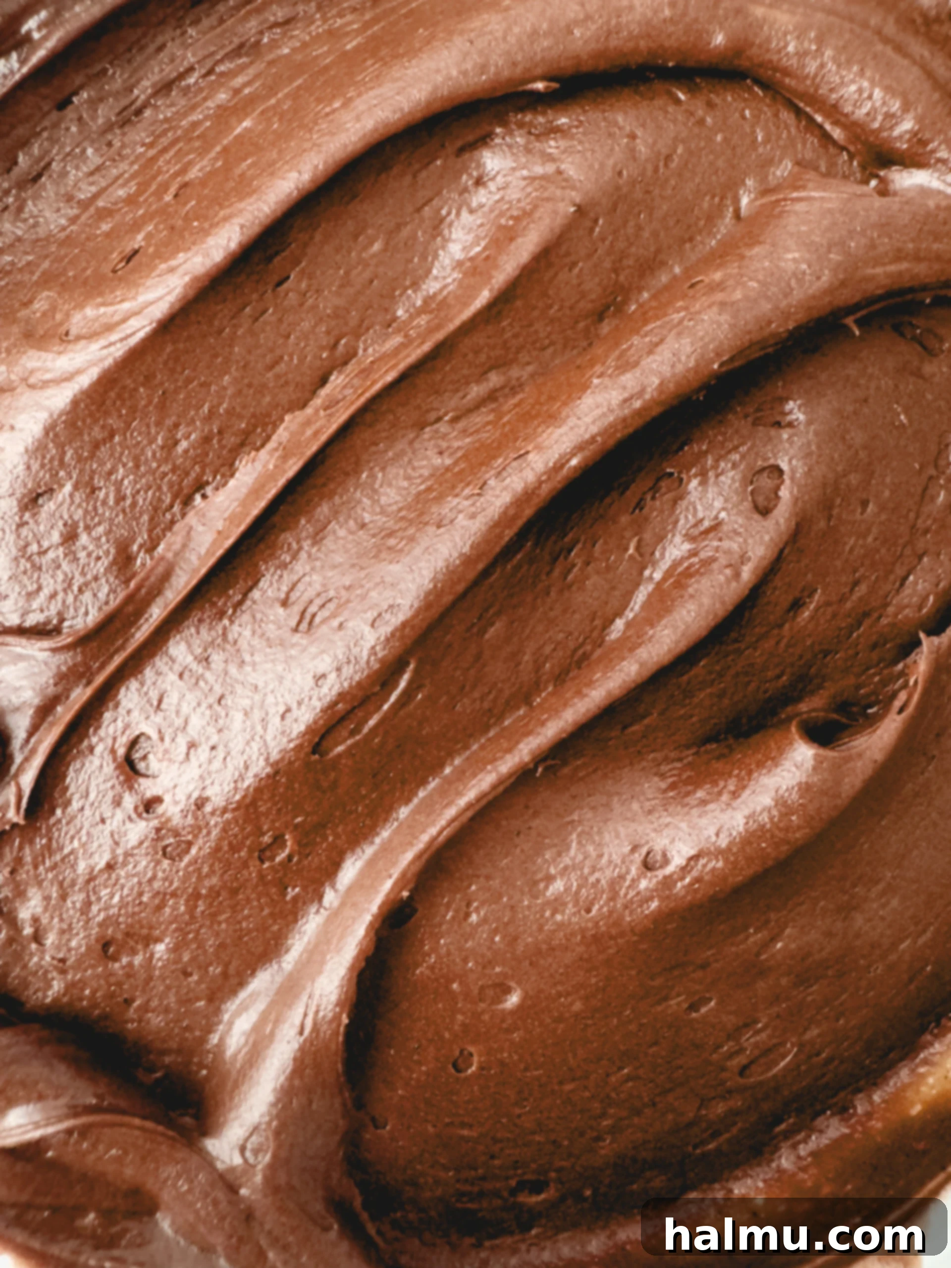Smooth and creamy chocolate cream cheese frosting in a mixing bowl, ready for application.