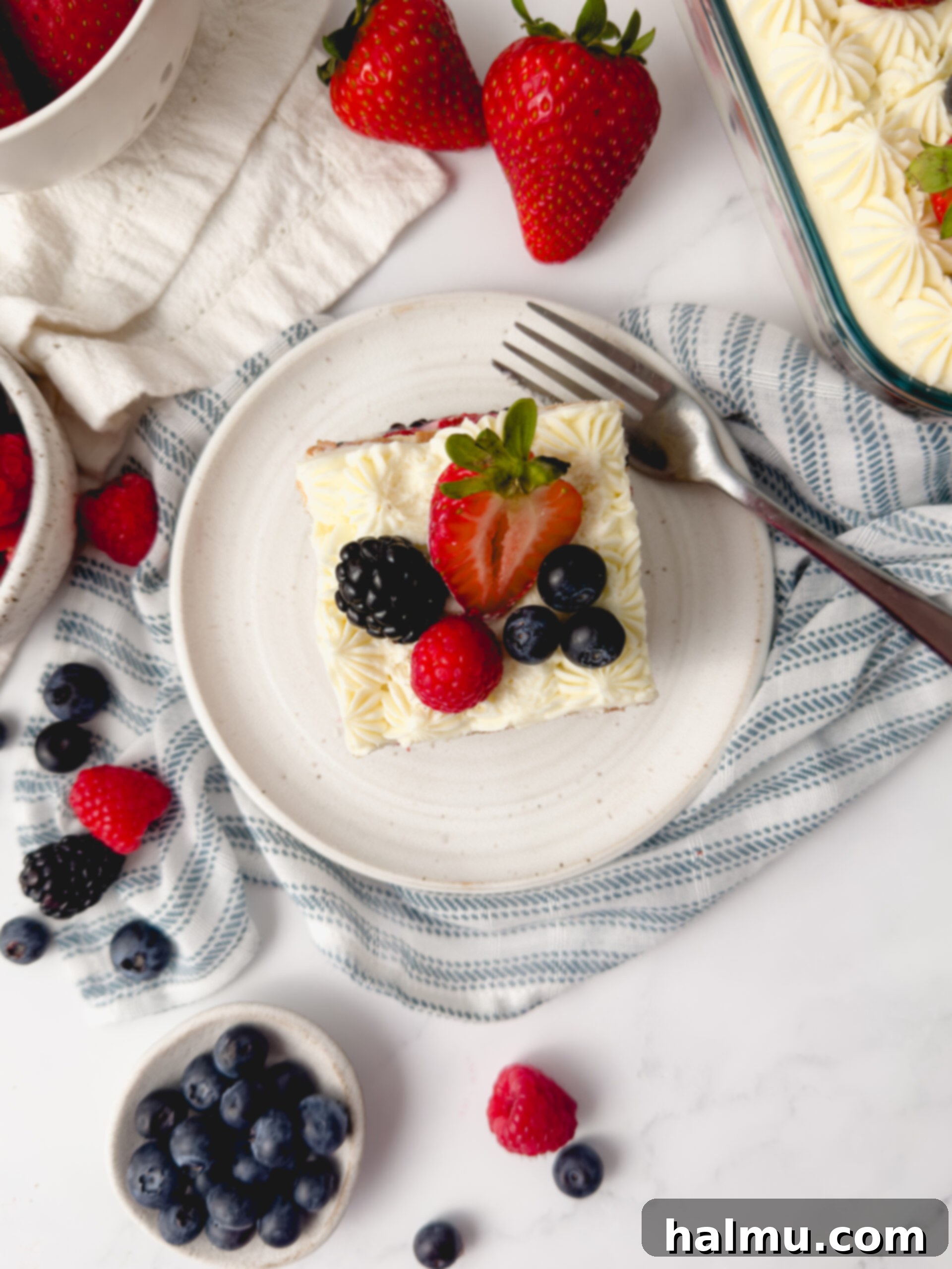 A slice of Berry Chantilly Tiramisu on a plate, showing the layers.