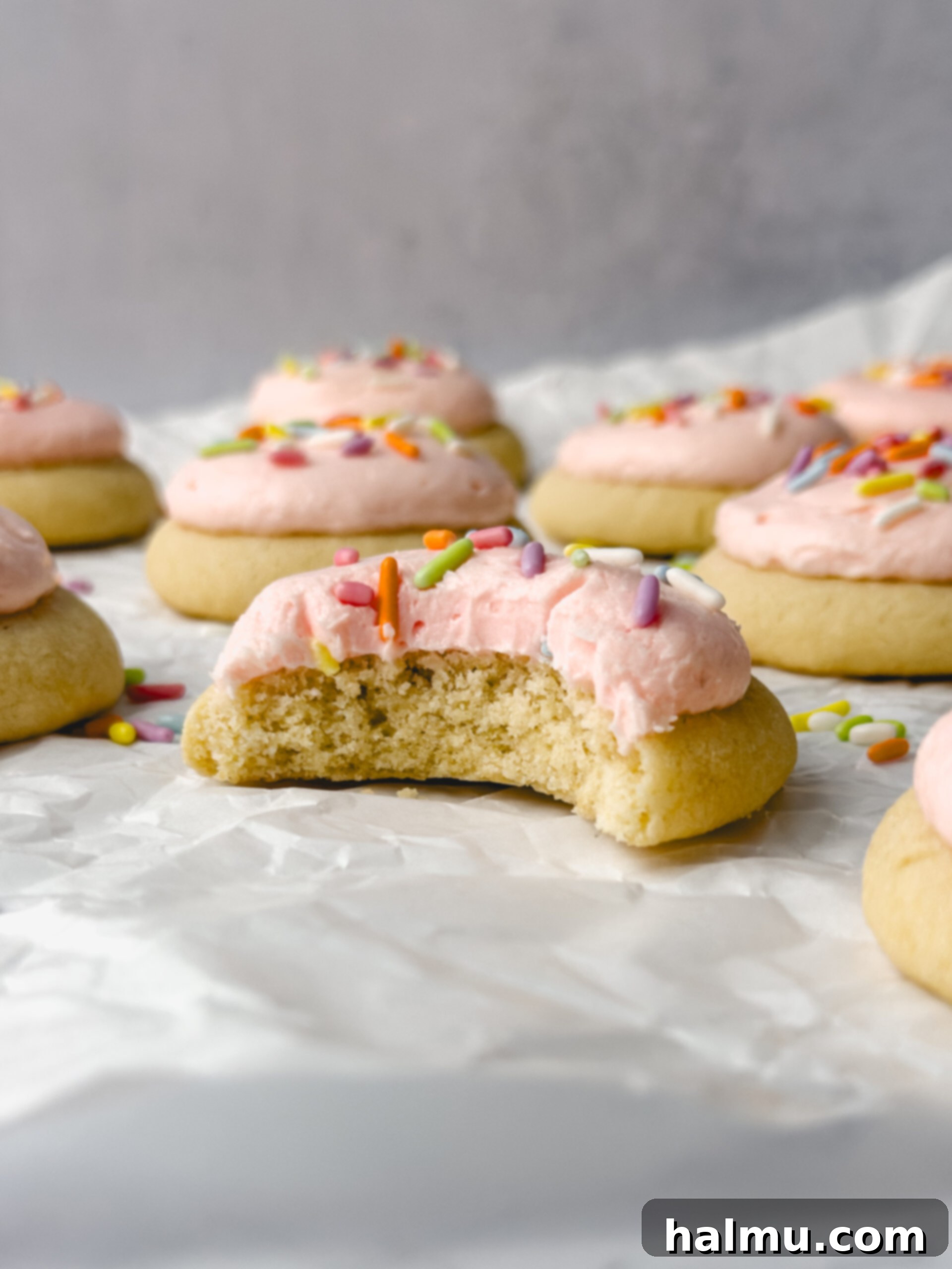 A stack of beautifully frosted mini sugar cookies.