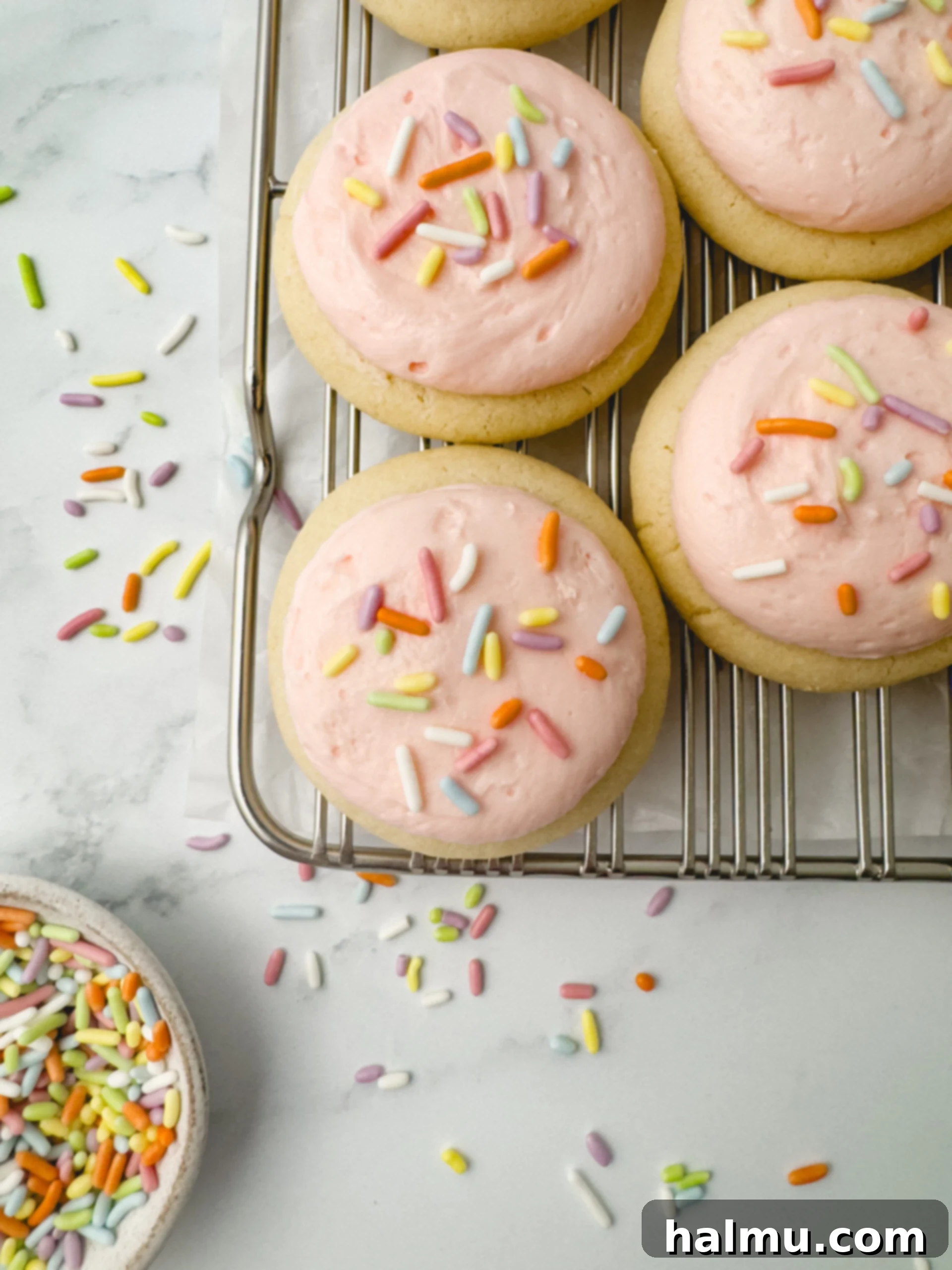 Close-up of baked mini sugar cookies on a cooling rack before frosting.