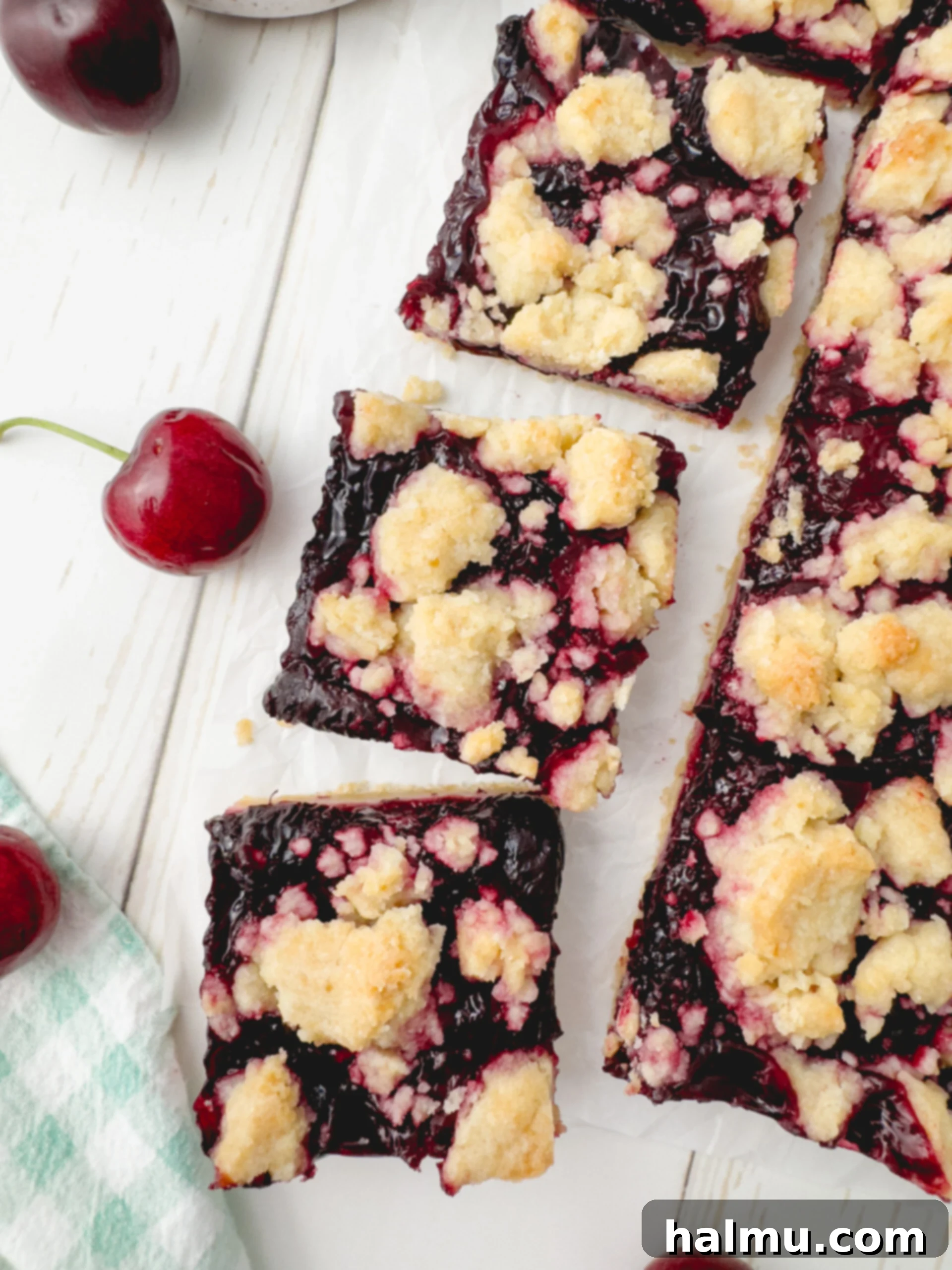 Freshly baked cherry crumb bars on a cooling rack, showcasing the golden shortbread and rich red cherry filling.