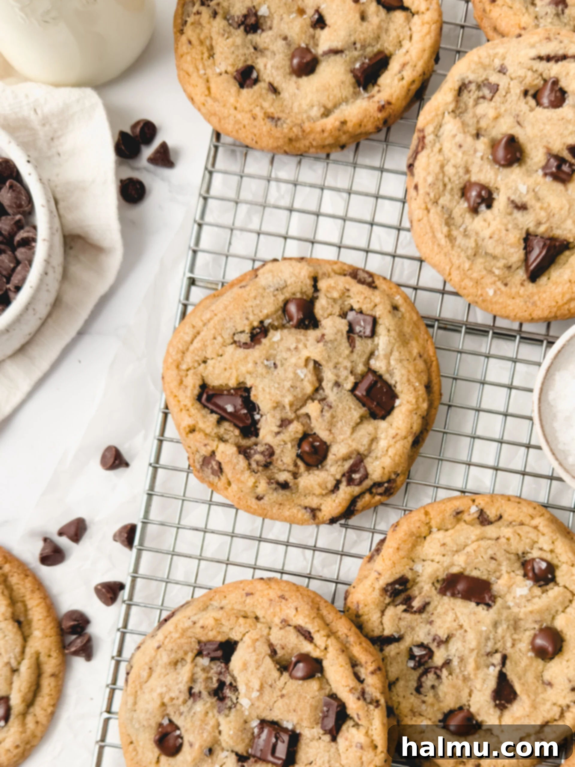 Freshly baked bakery-style chocolate chip cookies on a cooling rack.
