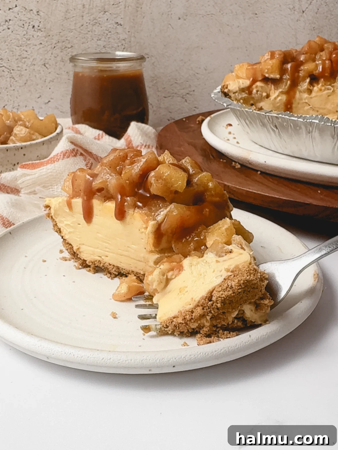 A closer, more artful shot of the Caramel Apple Cheesecake Pie, emphasizing its rich texture and appealing presentation.