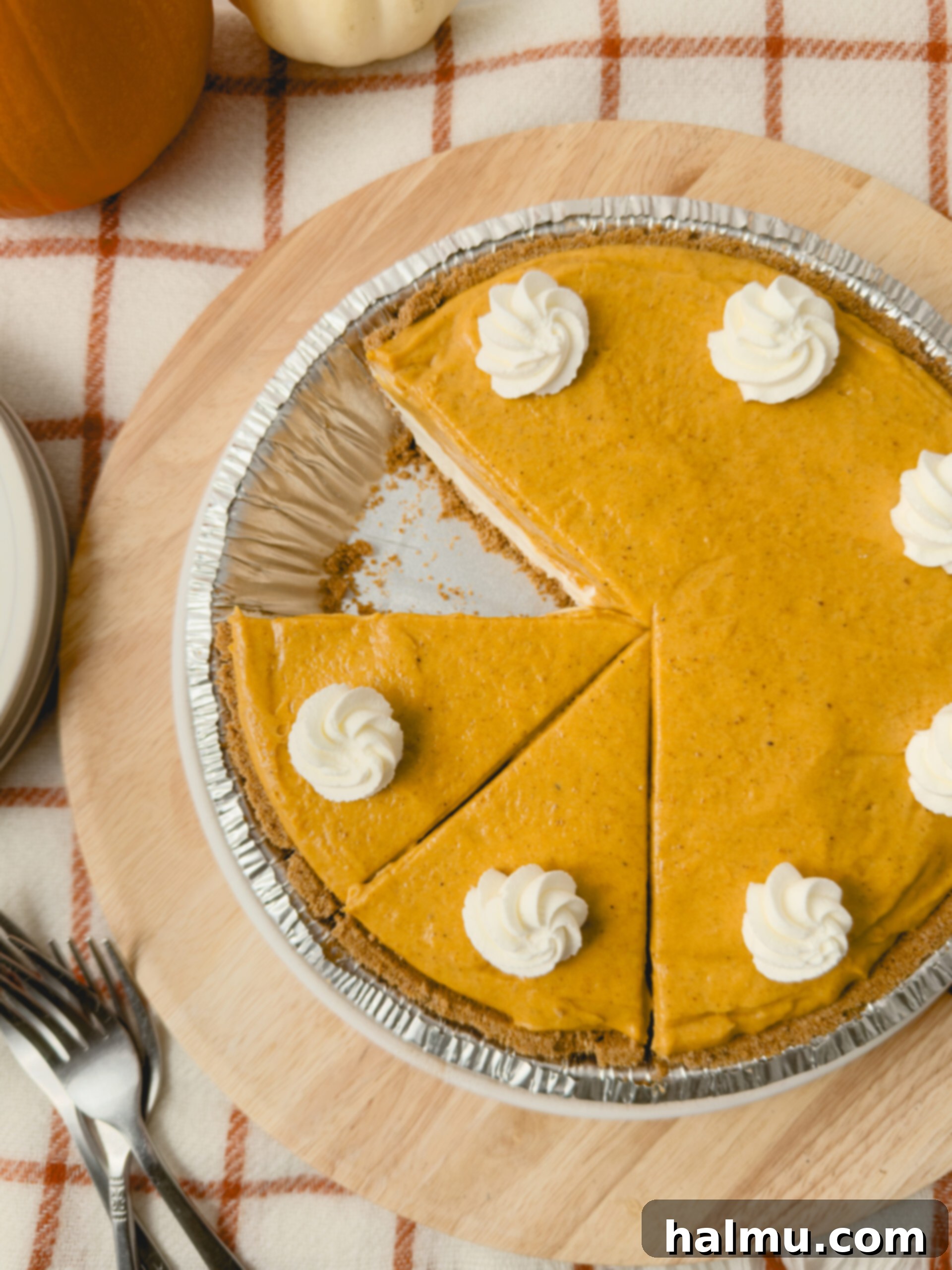 Close-up of the double layer pumpkin pie, showing the distinct cream cheese and pumpkin layers before chilling.