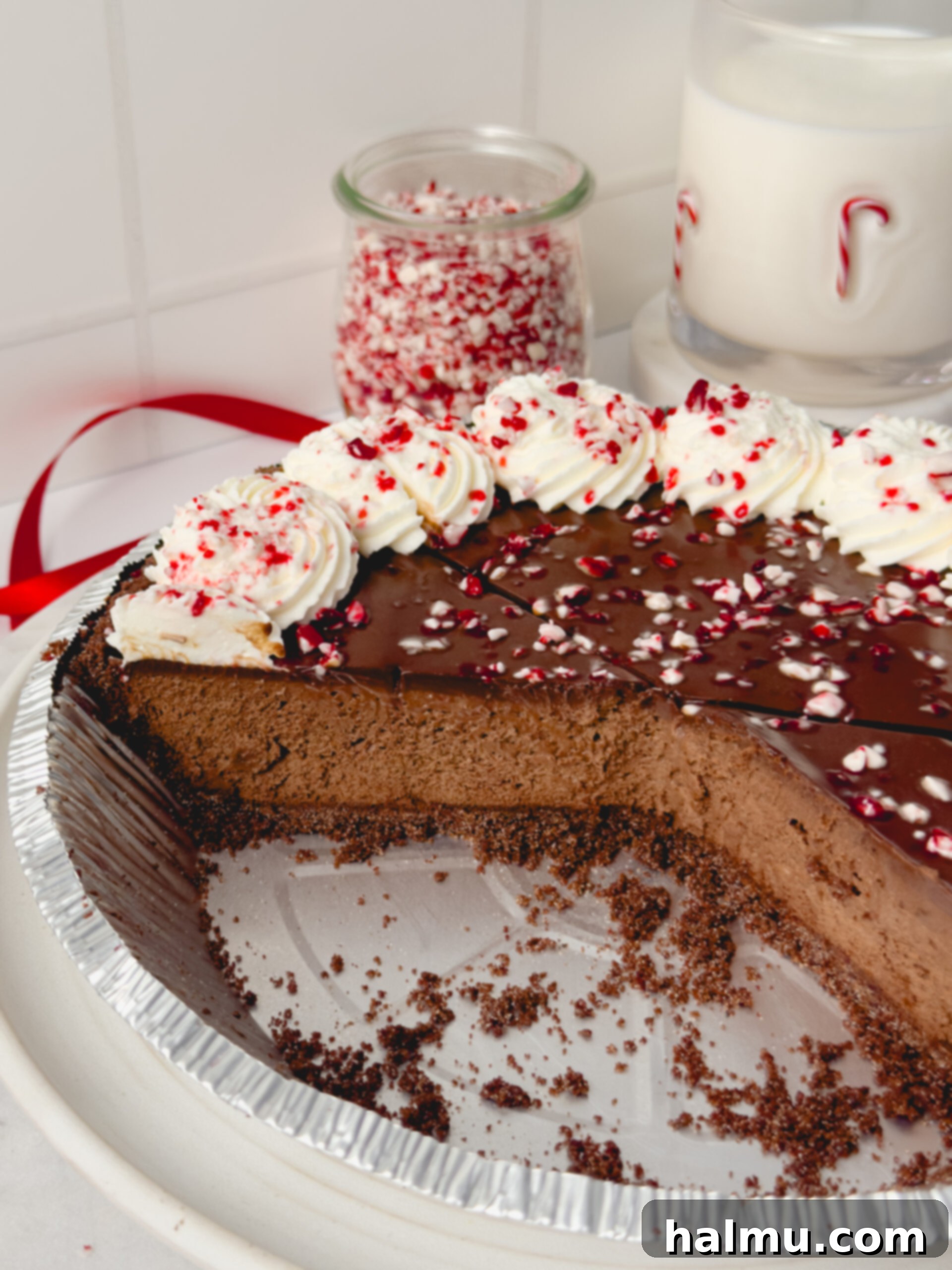 Decadent Chocolate Peppermint Dream 3 Close-up of the Chocolate Peppermint Pie, highlighting the smooth texture of the chocolate mousse and the vibrant crushed candy canes on top of the whipped cream.