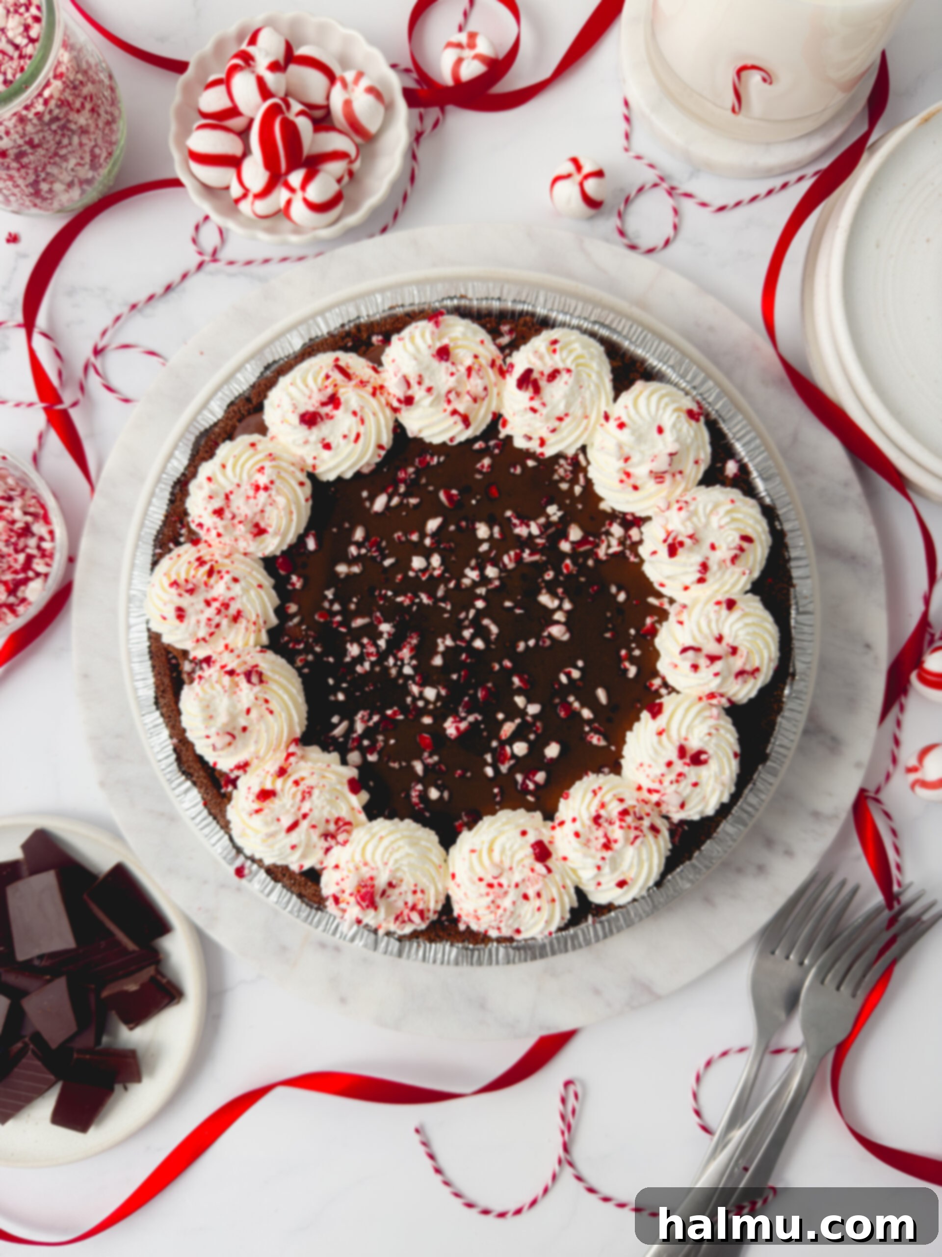 Decadent Chocolate Peppermint Dream 5 A top-down view of the finished Chocolate Peppermint Pie, adorned with piped whipped cream and glistening crushed candy canes.