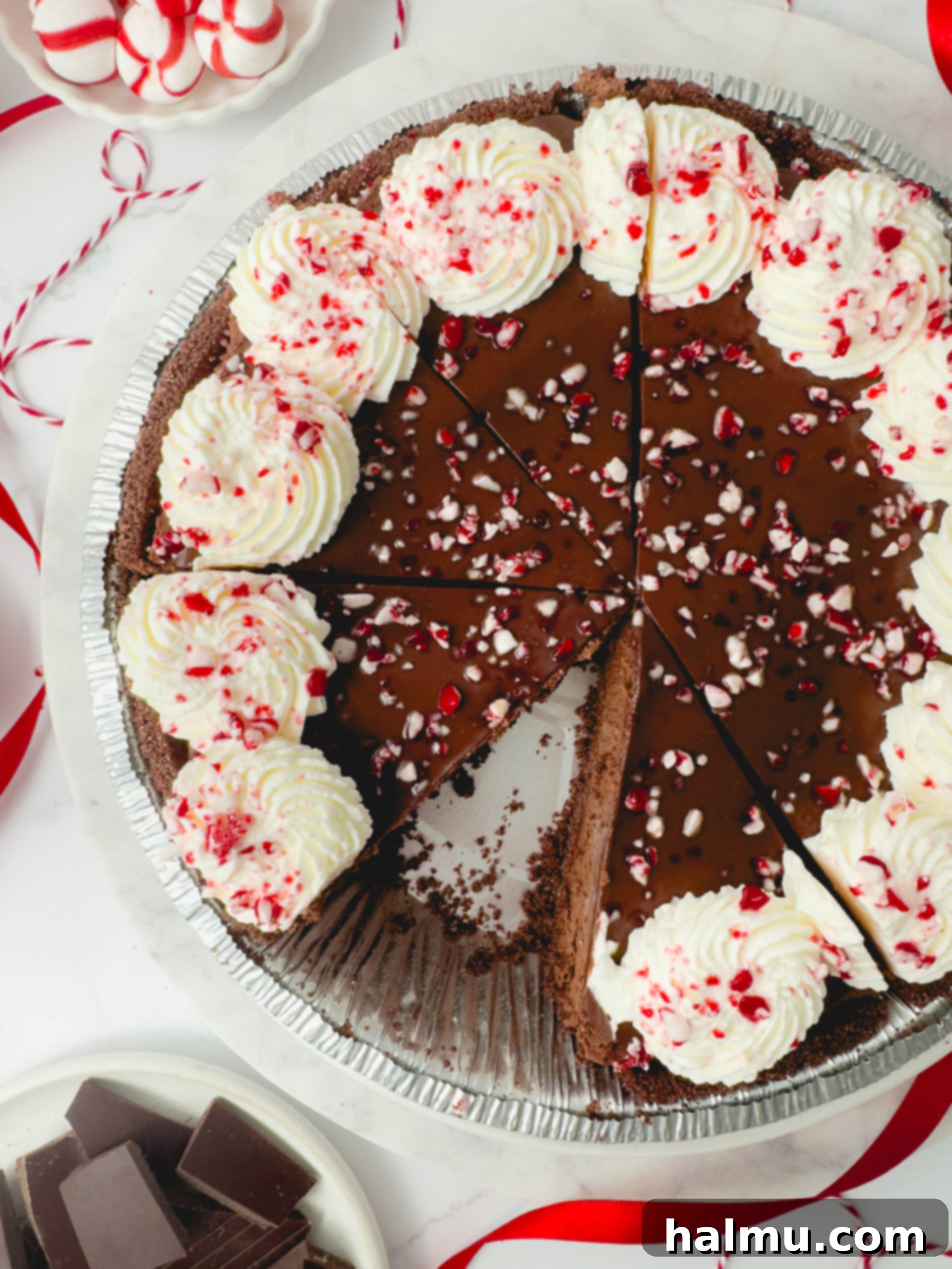 Decadent Chocolate Peppermint Dream 7 A side view of the Chocolate Peppermint Pie with a slice removed, revealing the perfect layers of crust, mousse, ganache, and whipped cream.