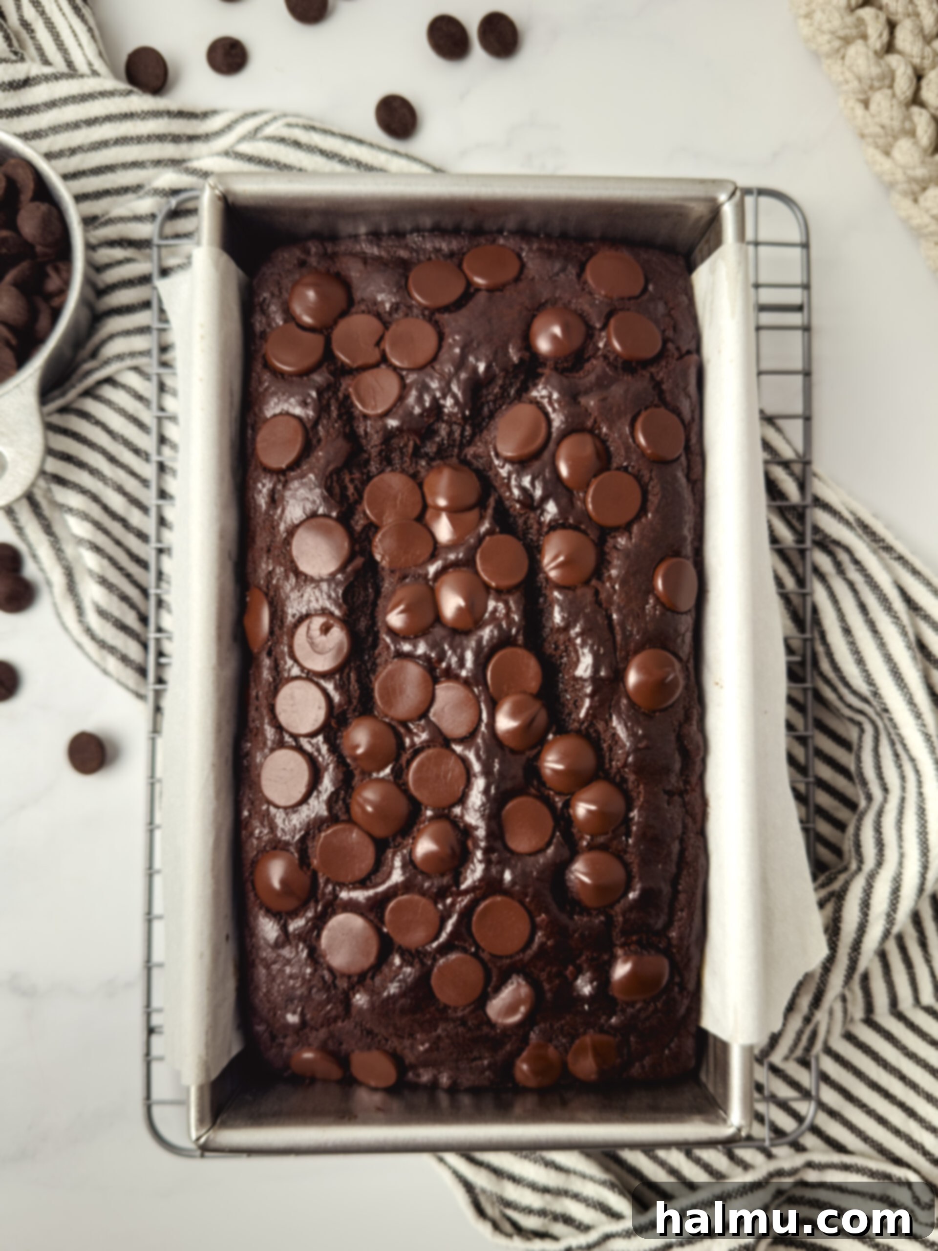Finished loaf of double chocolate banana bread on a cooling rack.