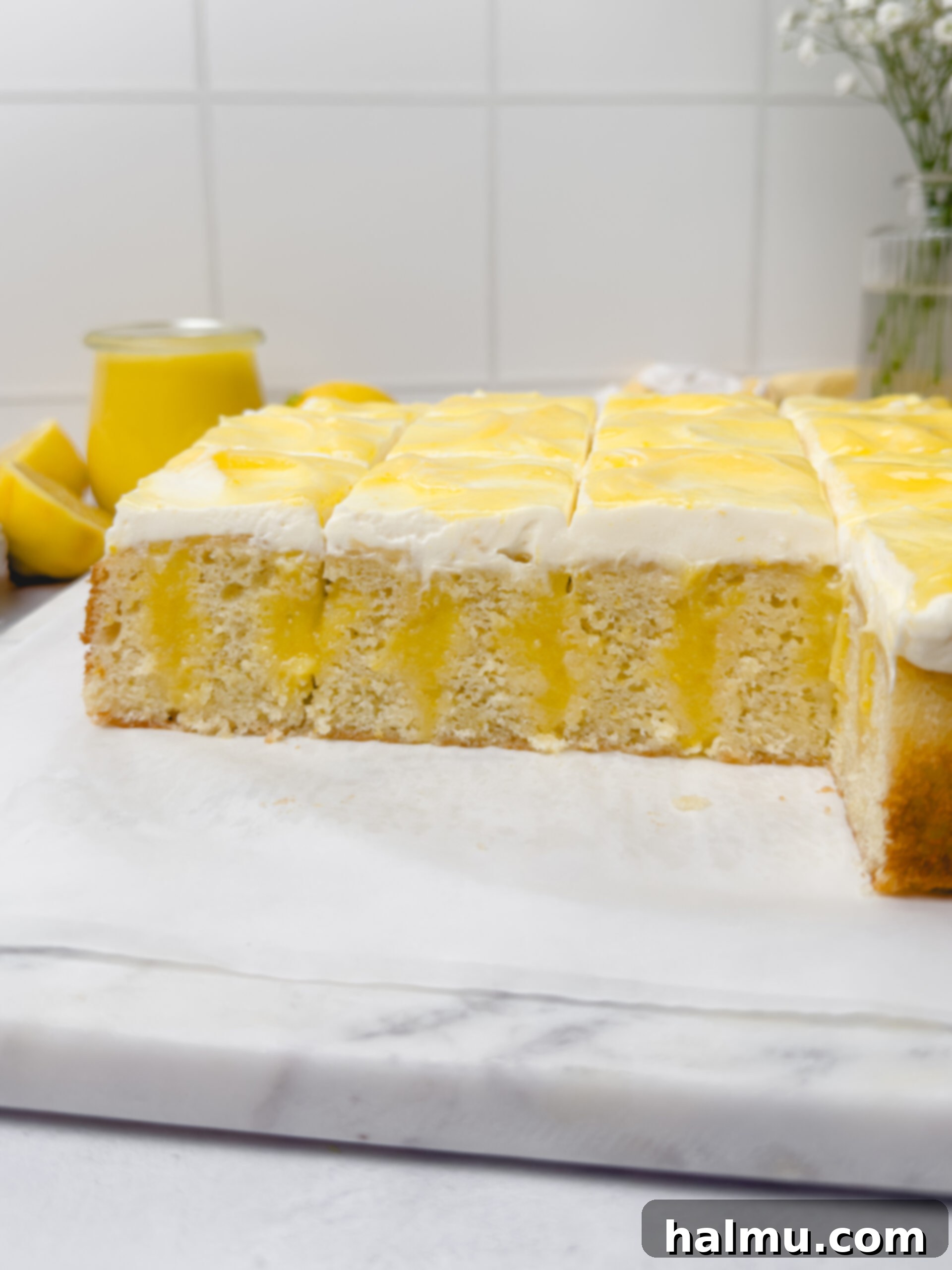 Close-up of a slice of Lemon Curd Cake with visible lemon curd pockets.