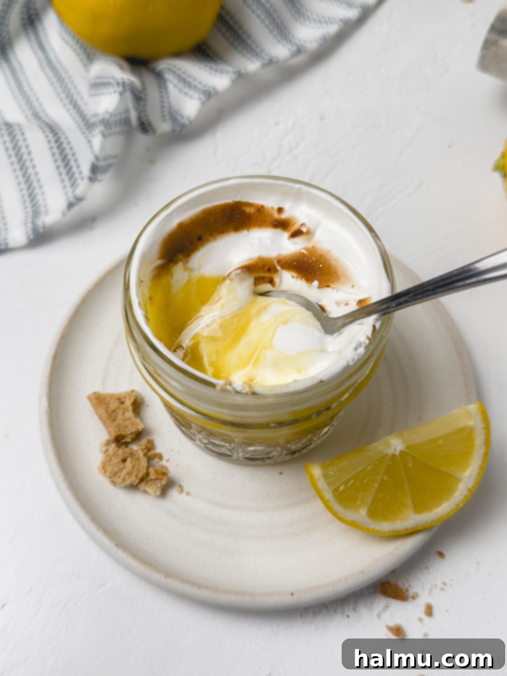 Various ingredients for lemon meringue pie cups, including lemons, eggs, and a zester.