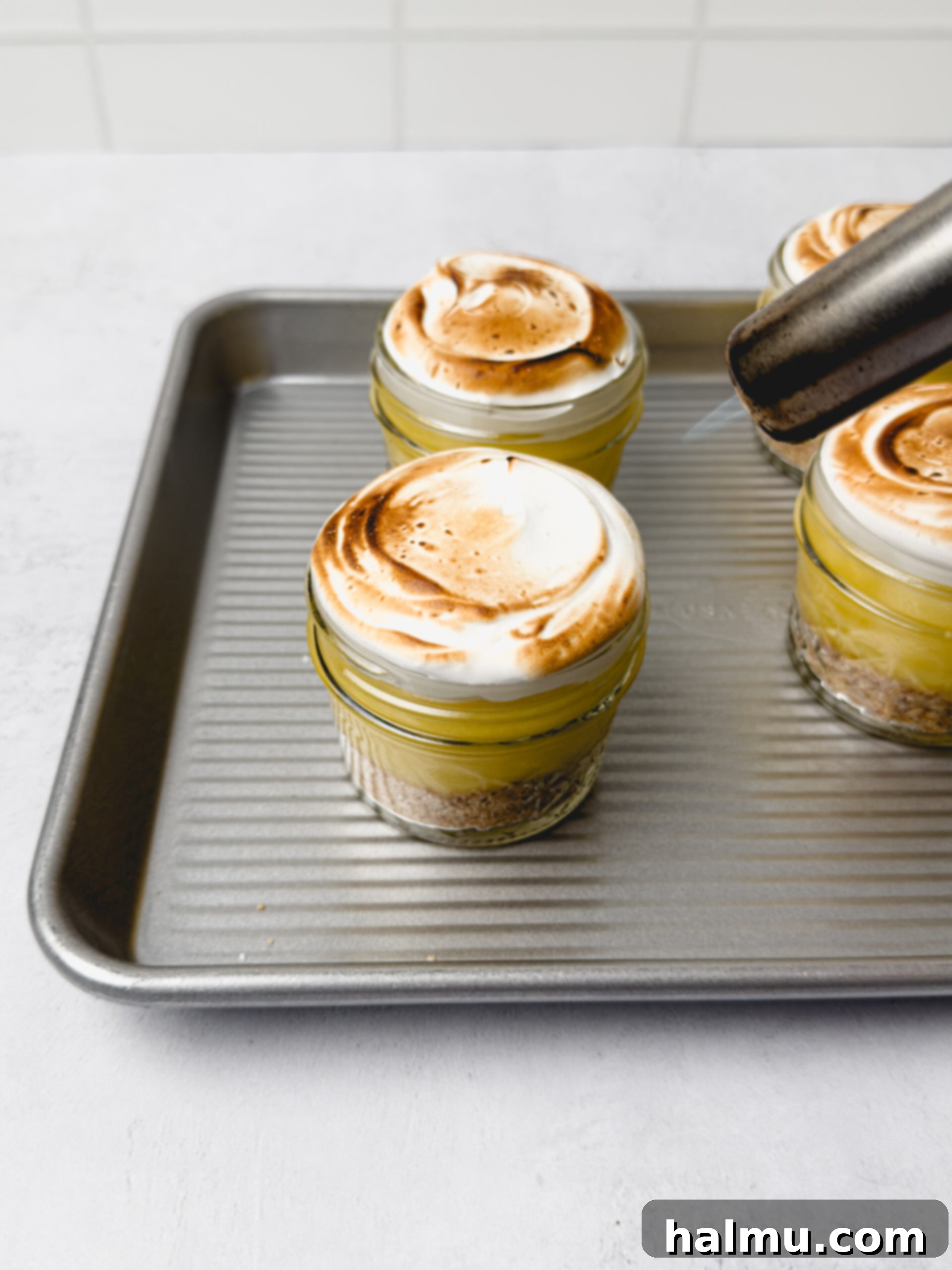 A completed No-Bake Lemon Meringue Pie Cup with a golden toasted meringue.