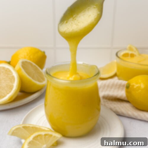 Zesty Lemon Cream 9 A jar of freshly made lemon curd, smooth and golden yellow, perfect for various desserts.