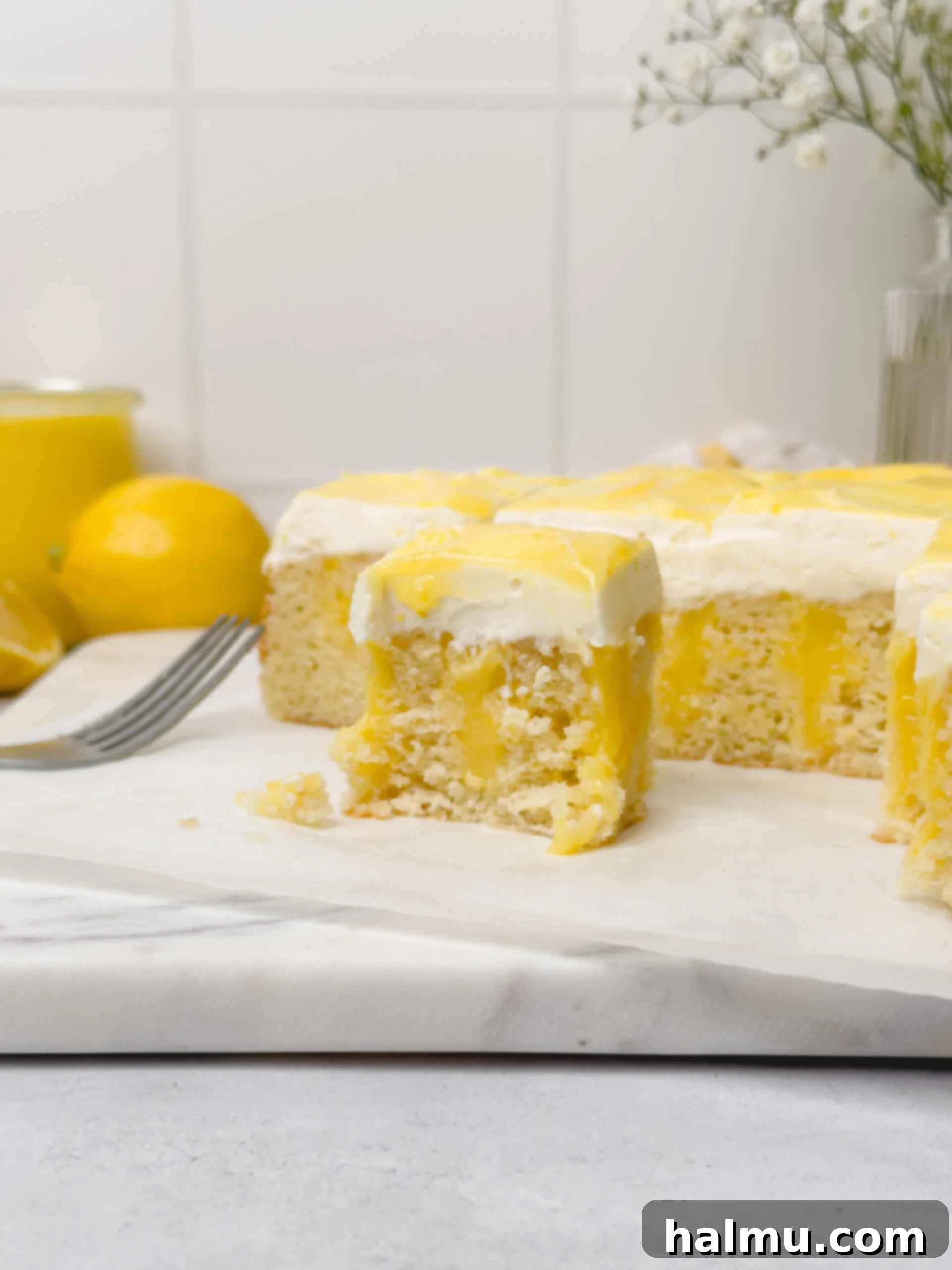 Zesty Lemon Cream 4 A small jar of lemon curd next to a spoon, ready to be enjoyed or served with dessert.