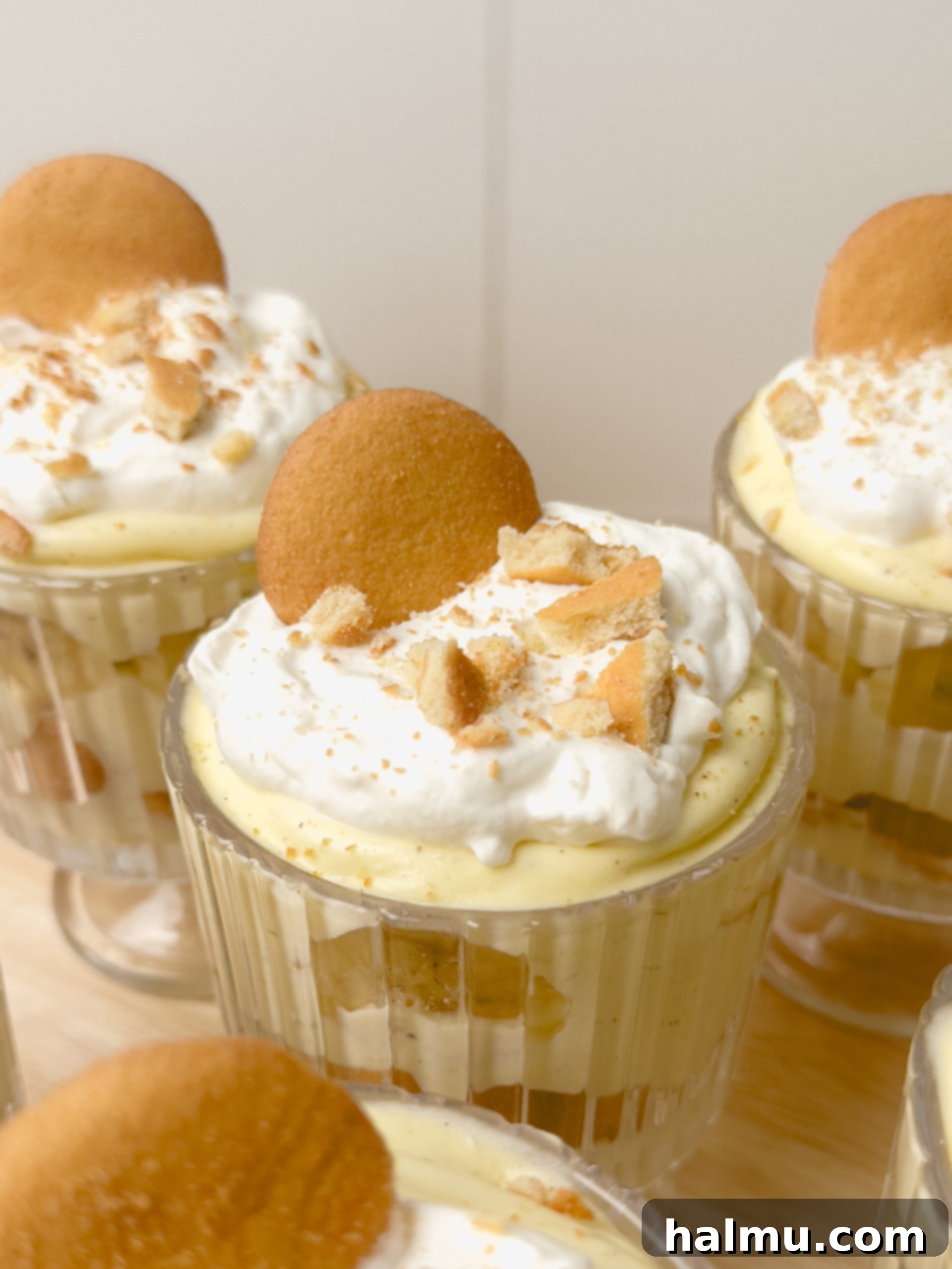 Close-up of layers in a banana pudding cup, showing wafers, bananas, and cream
