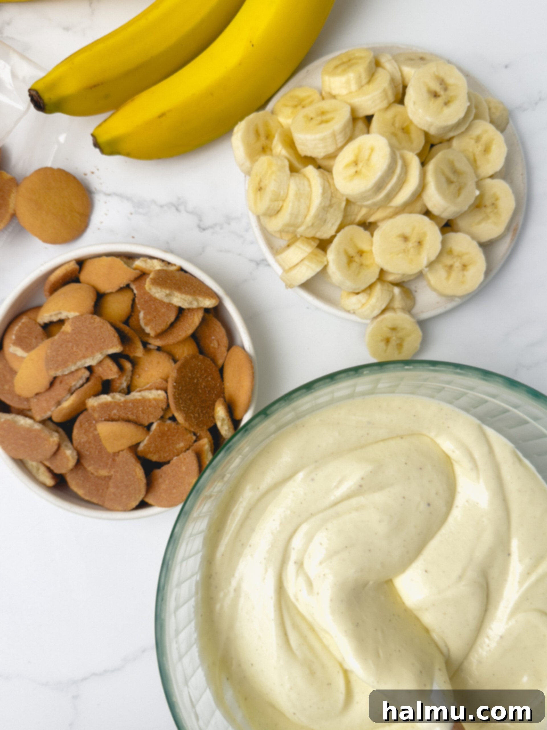 Finished individual banana pudding cups with extra wafers and a spoon