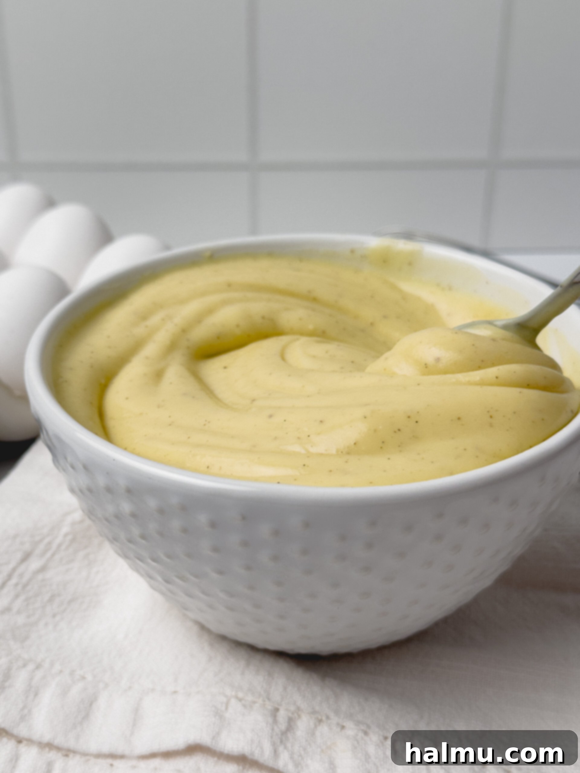Velvety Vanilla Dream 12 A bowl of finished vanilla pastry cream with a spoon, showing the creamy texture and inviting presentation.