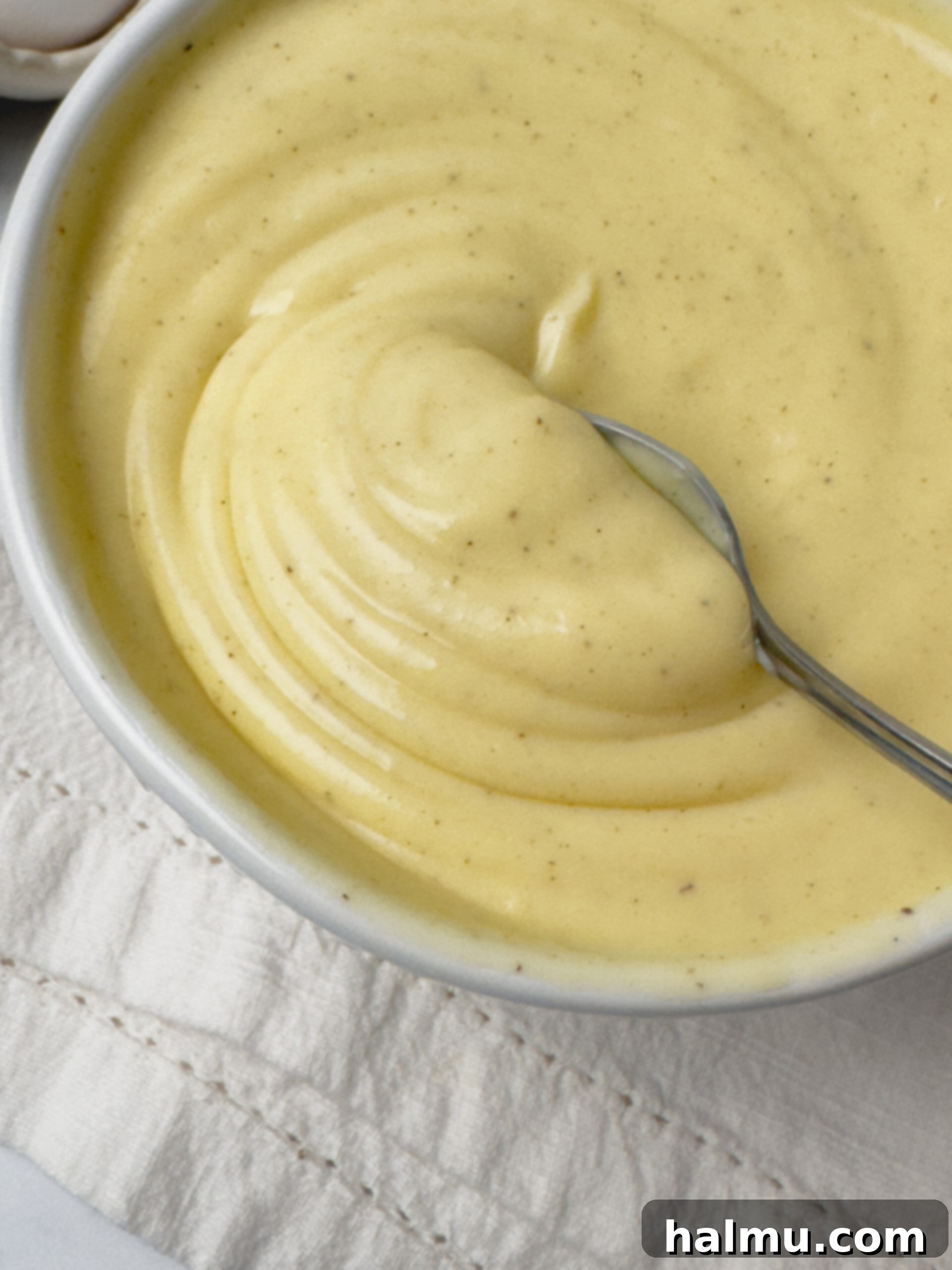 Velvety Vanilla Dream 3 A bowl of freshly made Vanilla Pastry Cream, showcasing its smooth texture and golden hue.