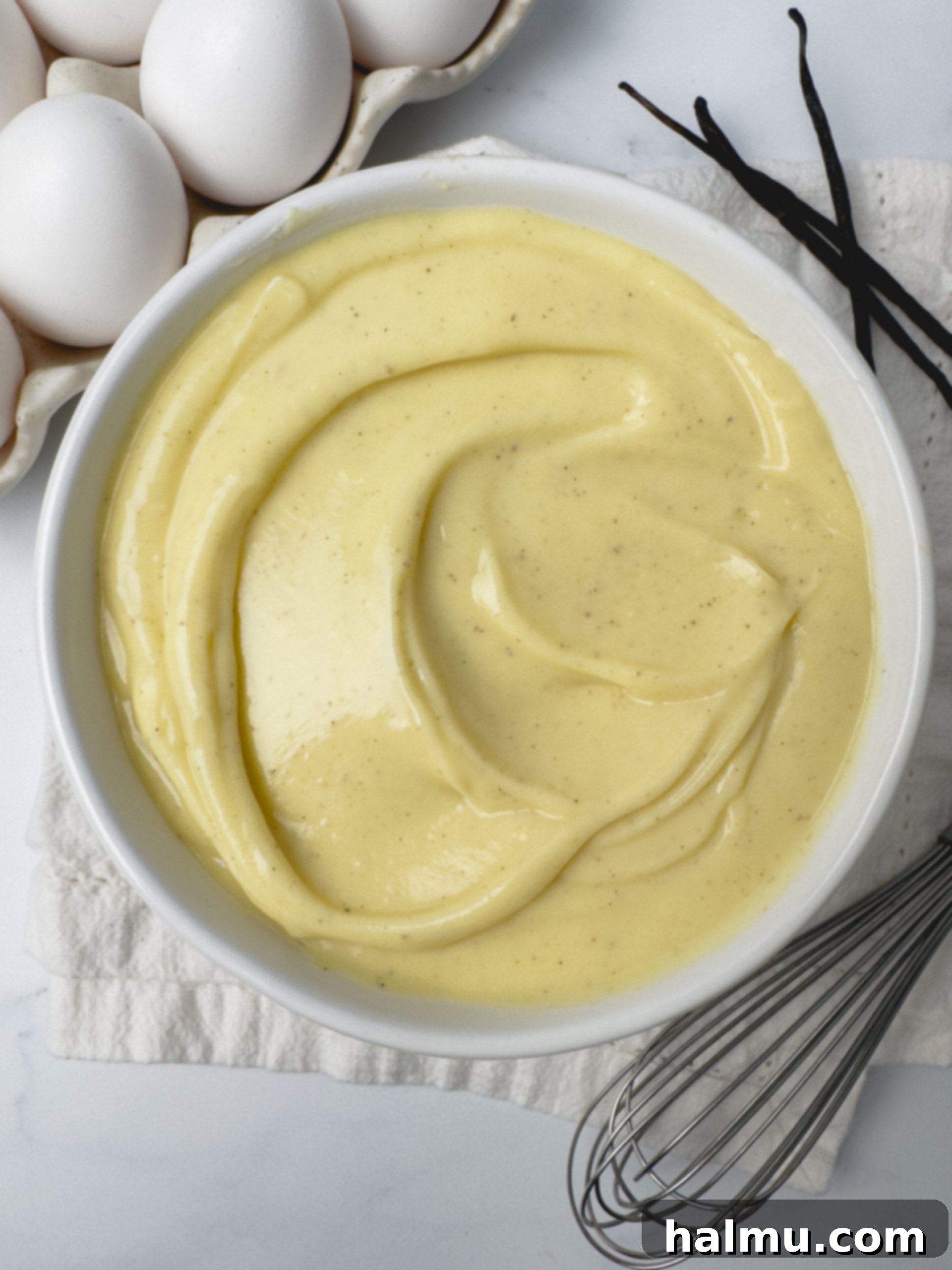 Velvety Vanilla Dream 5 Ingredients laid out for making vanilla pastry cream, including milk, sugar, eggs, butter, and vanilla bean paste.