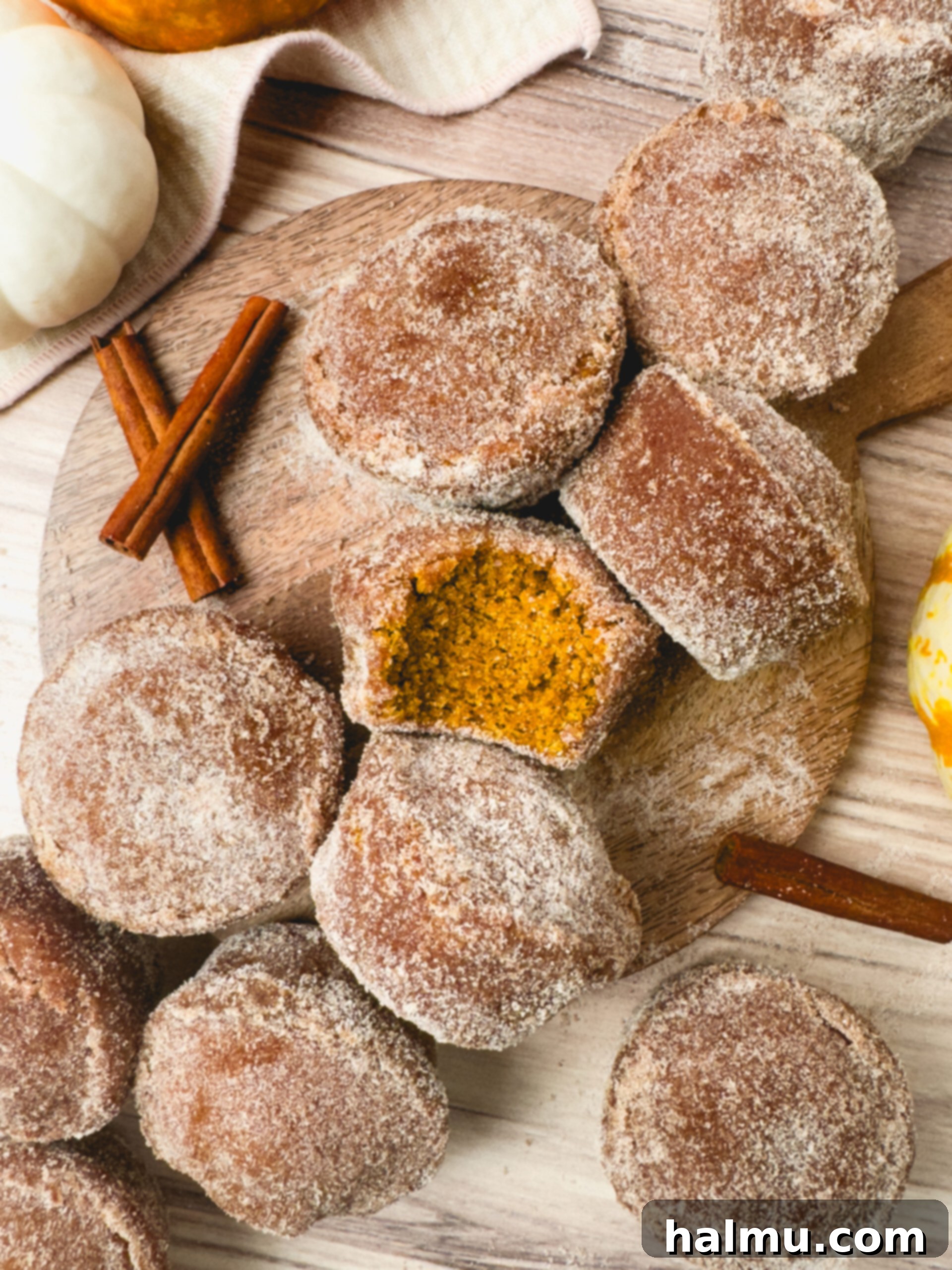 Pumpkin Spice Donut Muffins 7 A stack of warm Pumpkin Donut Muffins with cinnamon sugar.