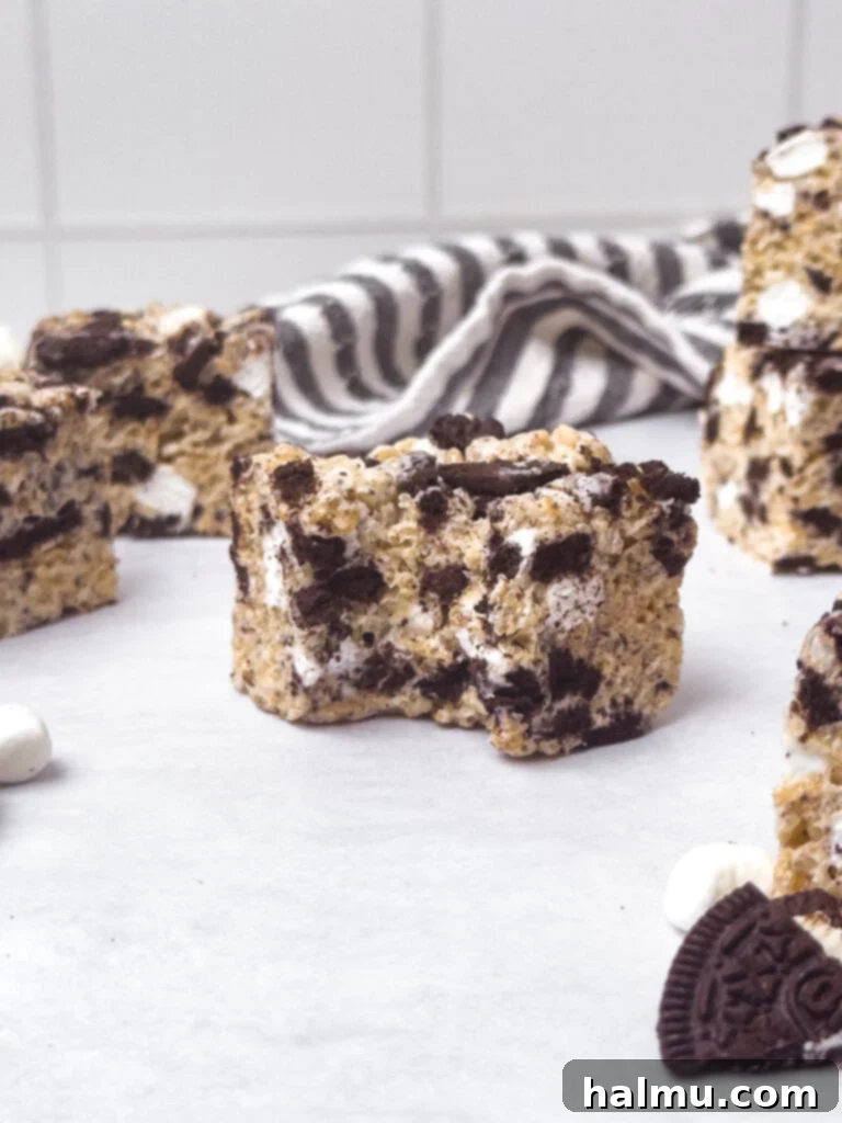 Oreo Krispie Treats 8 Several Oreo Rice Krispie Treats arranged on a white plate, ready to eat.