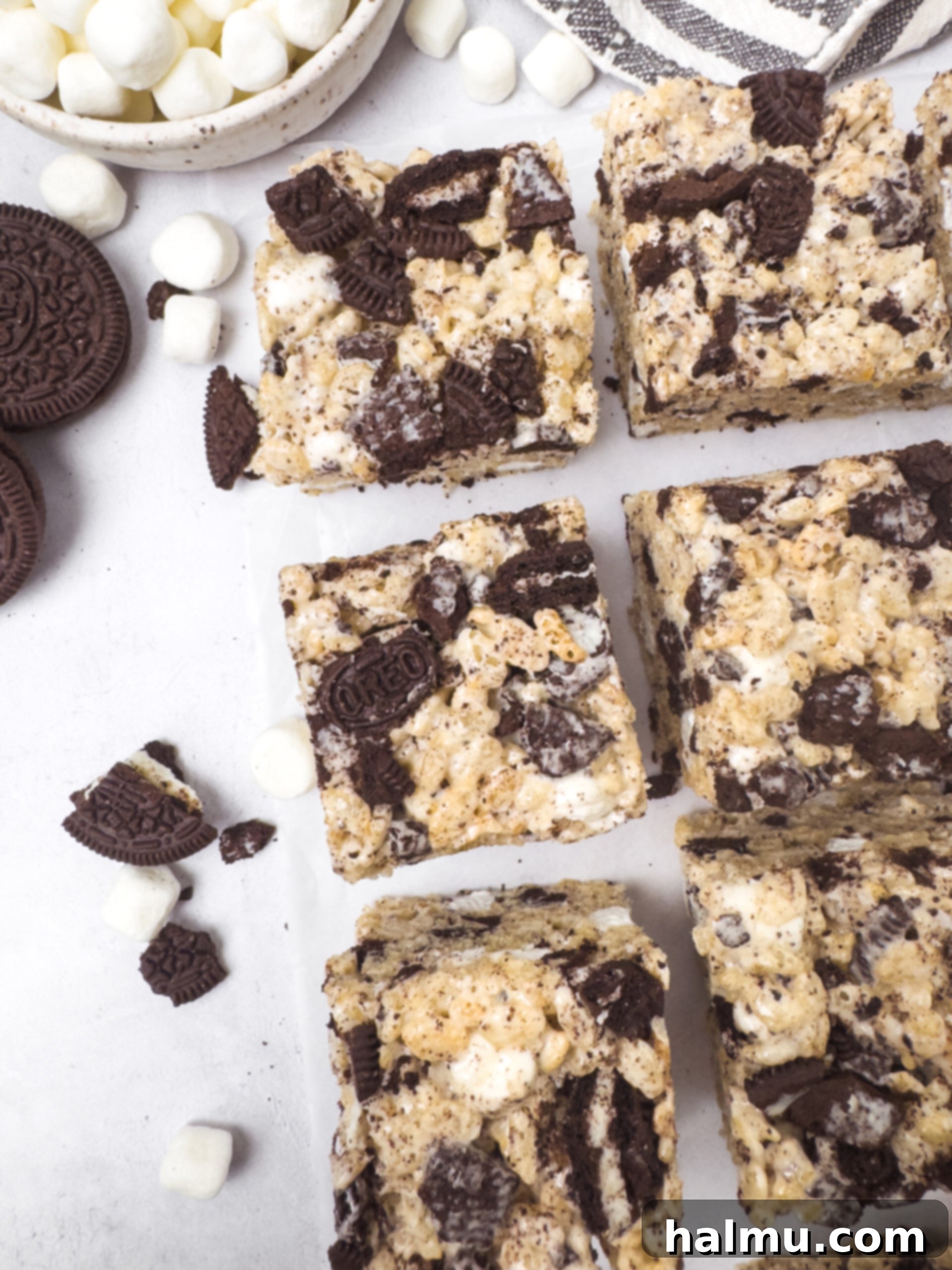 Oreo Krispie Treats 7 Several cut Oreo Rice Krispie Treats on a white background, showing the cookie and marshmallow.