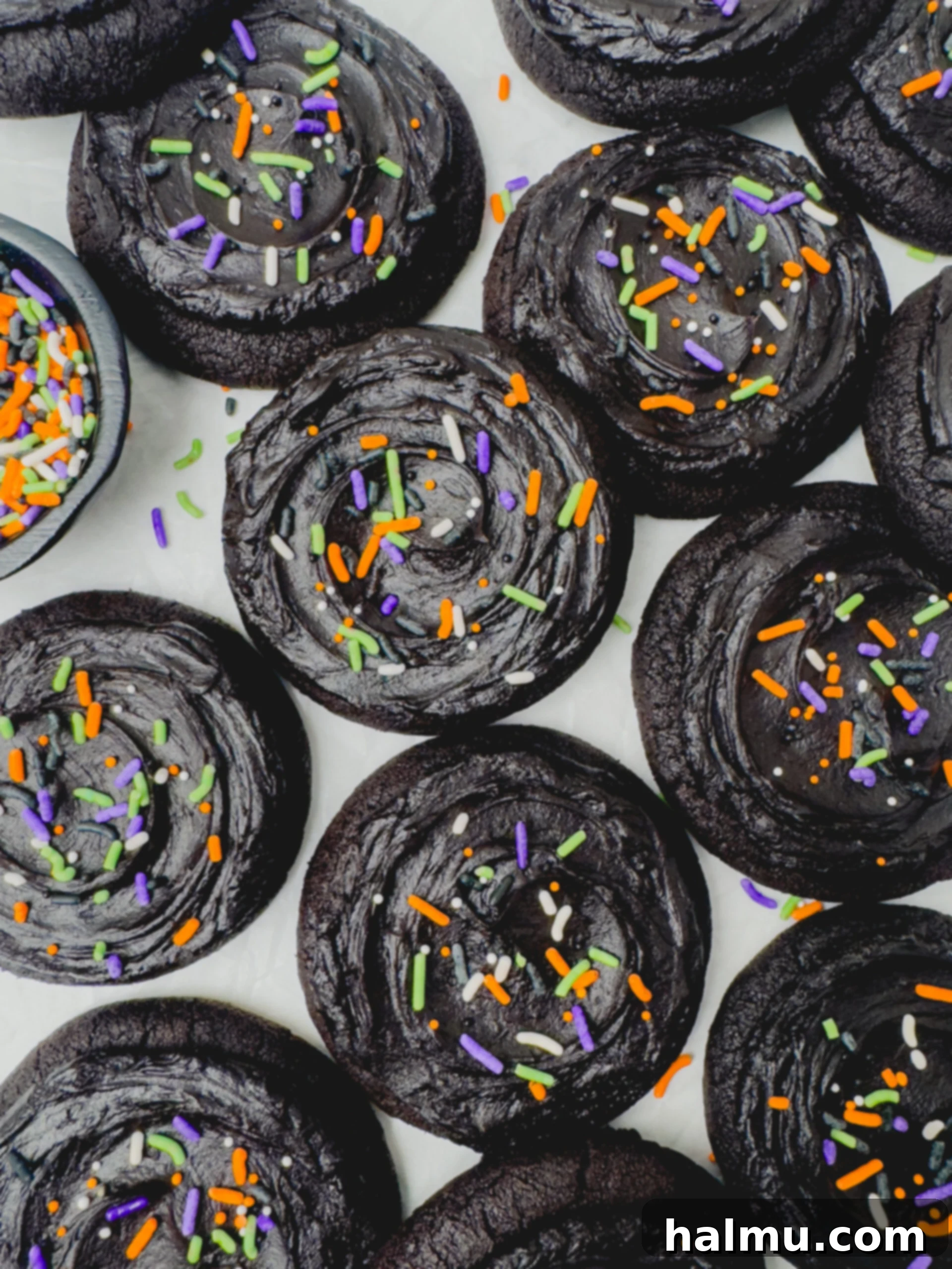 Frosted Black Cocoa Cookies with festive sprinkles, a dark, fudgy cookie perfect for Halloween.
