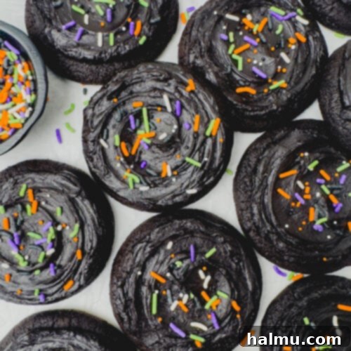 Frosted Black Cocoa Cookies with festive sprinkles