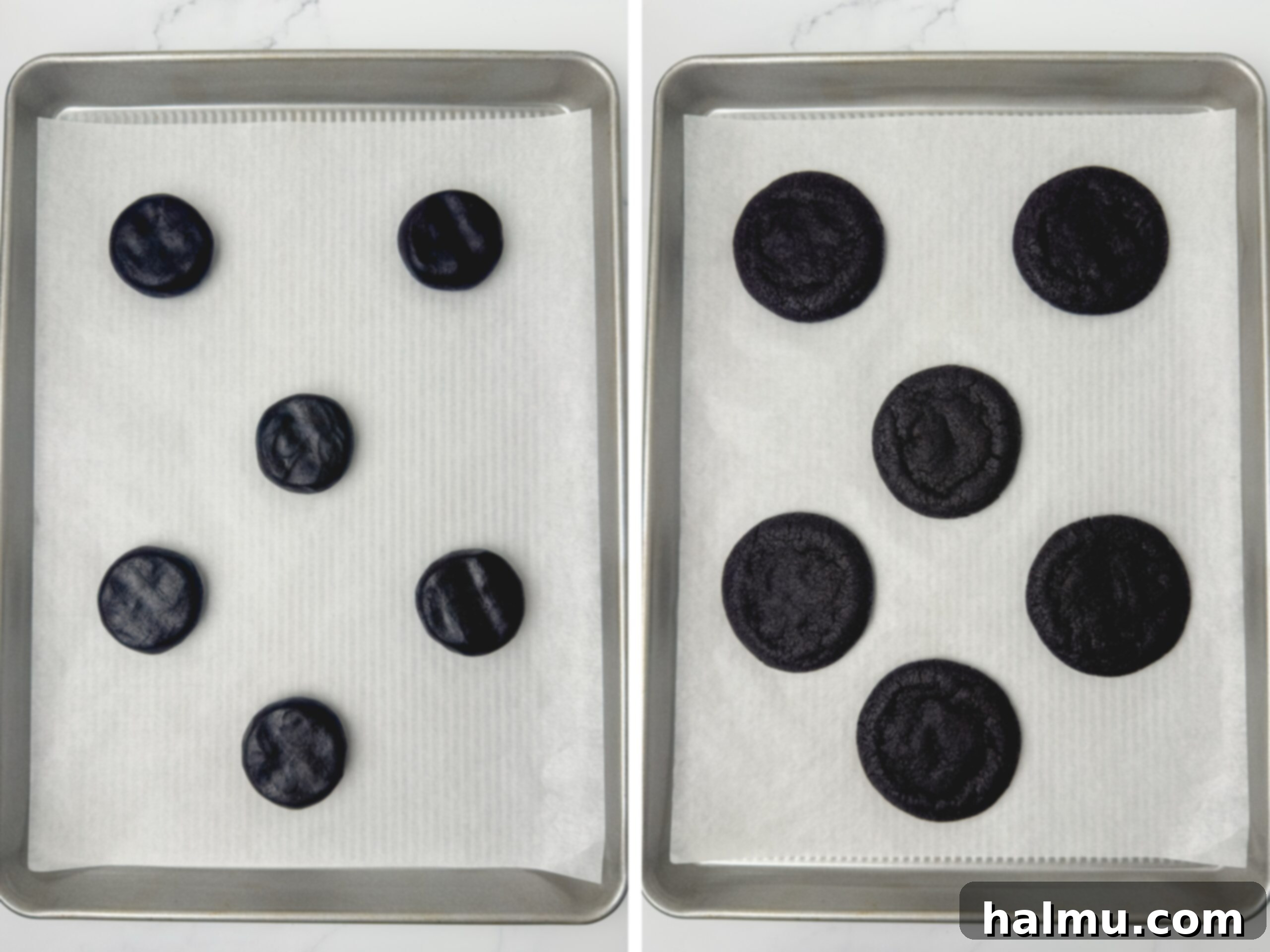 A close-up of a hand using a mini offset spatula to spread black cocoa buttercream on a freshly baked black cocoa cookie.